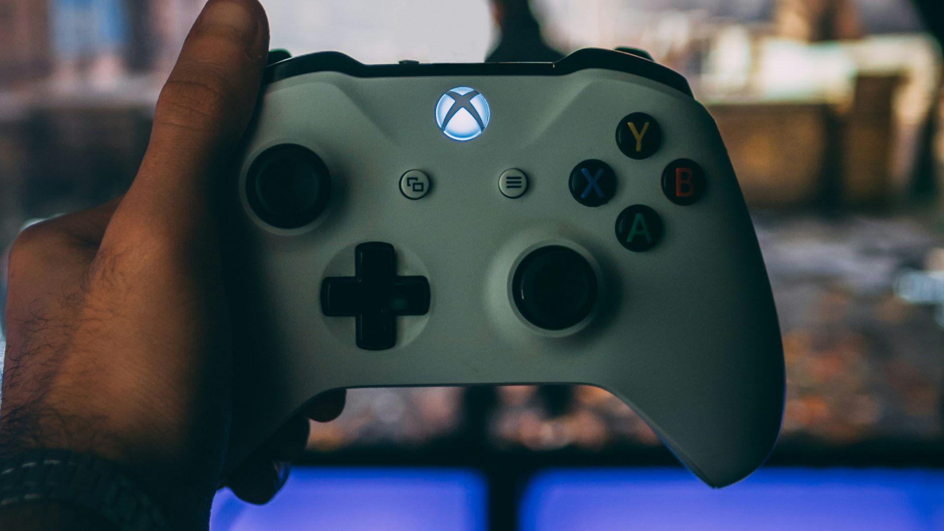 person holding white xbox one controller