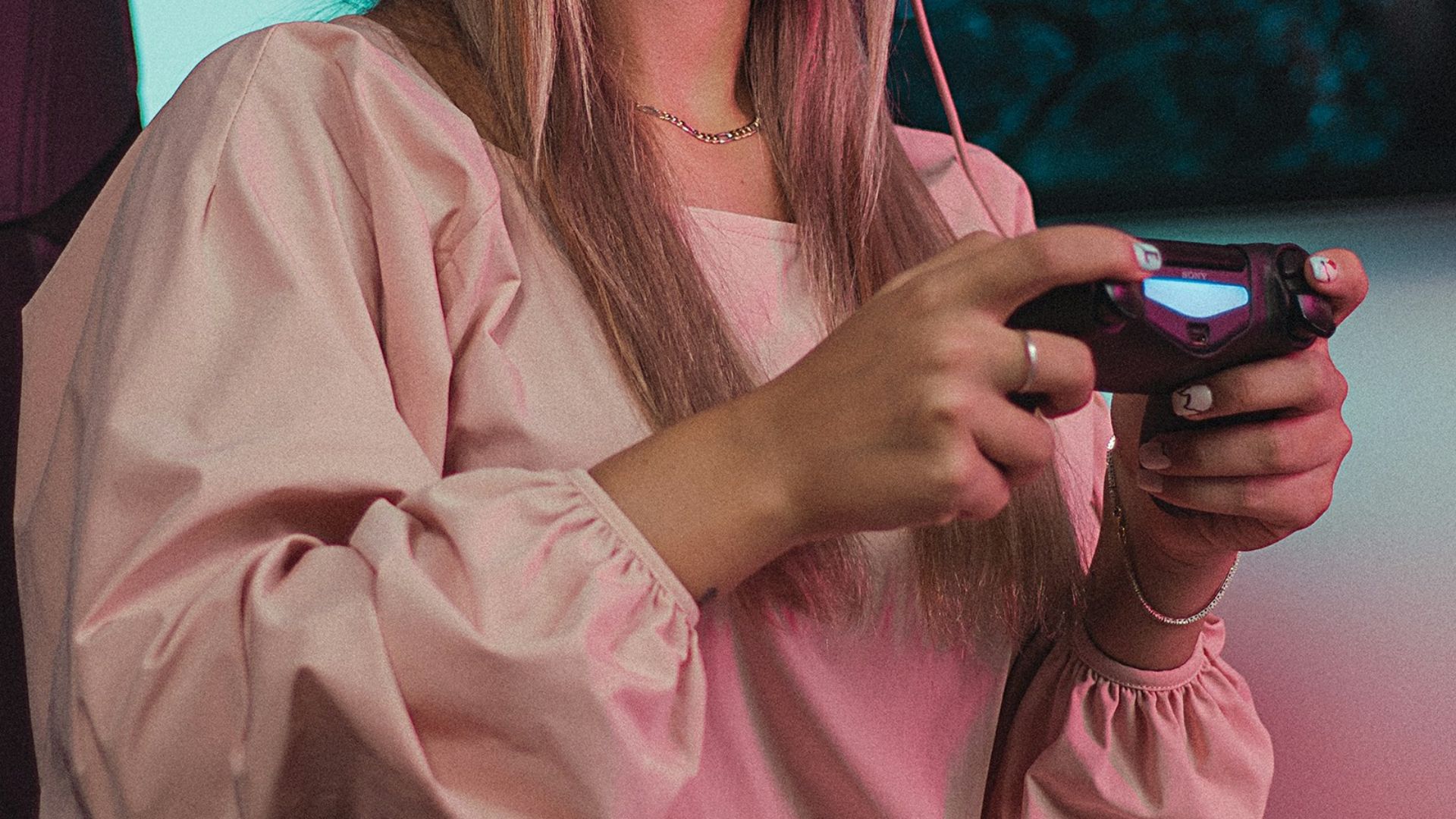 a woman wearing headphones and a pink dress