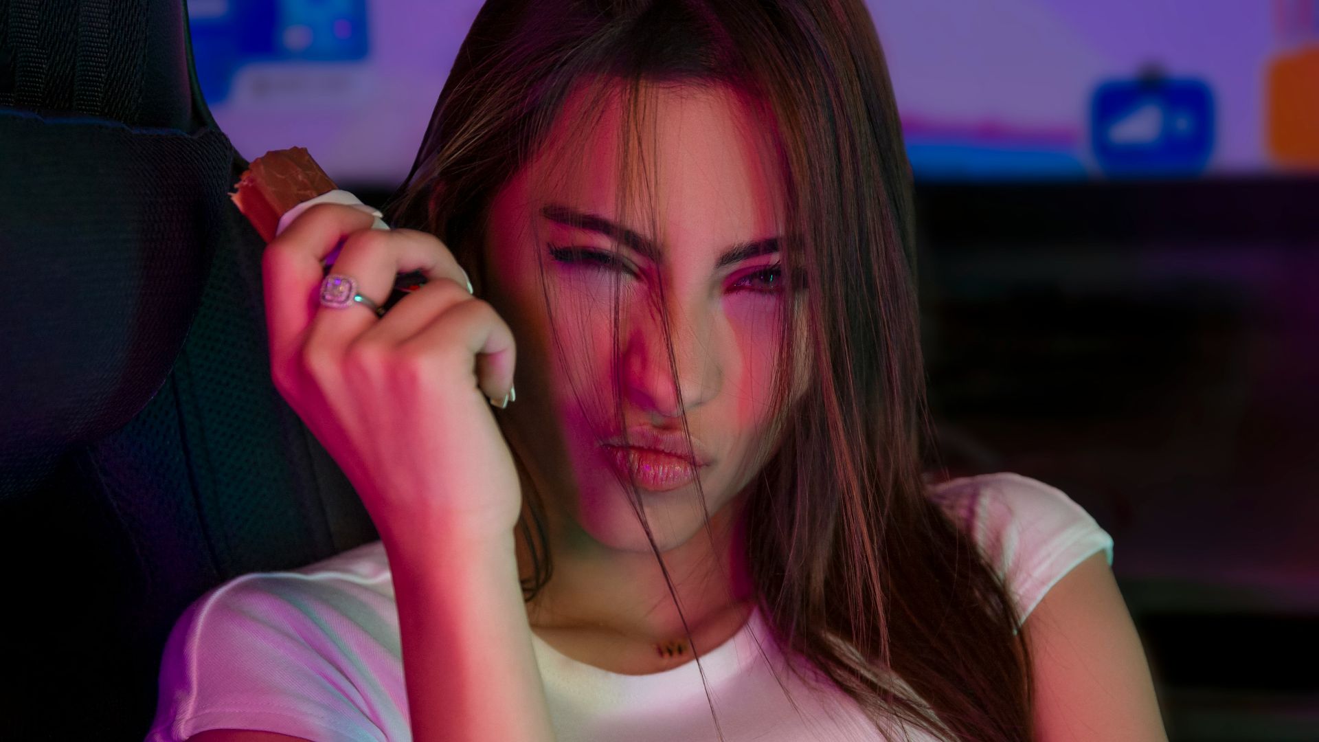 A woman sitting in a car talking on a cell phone