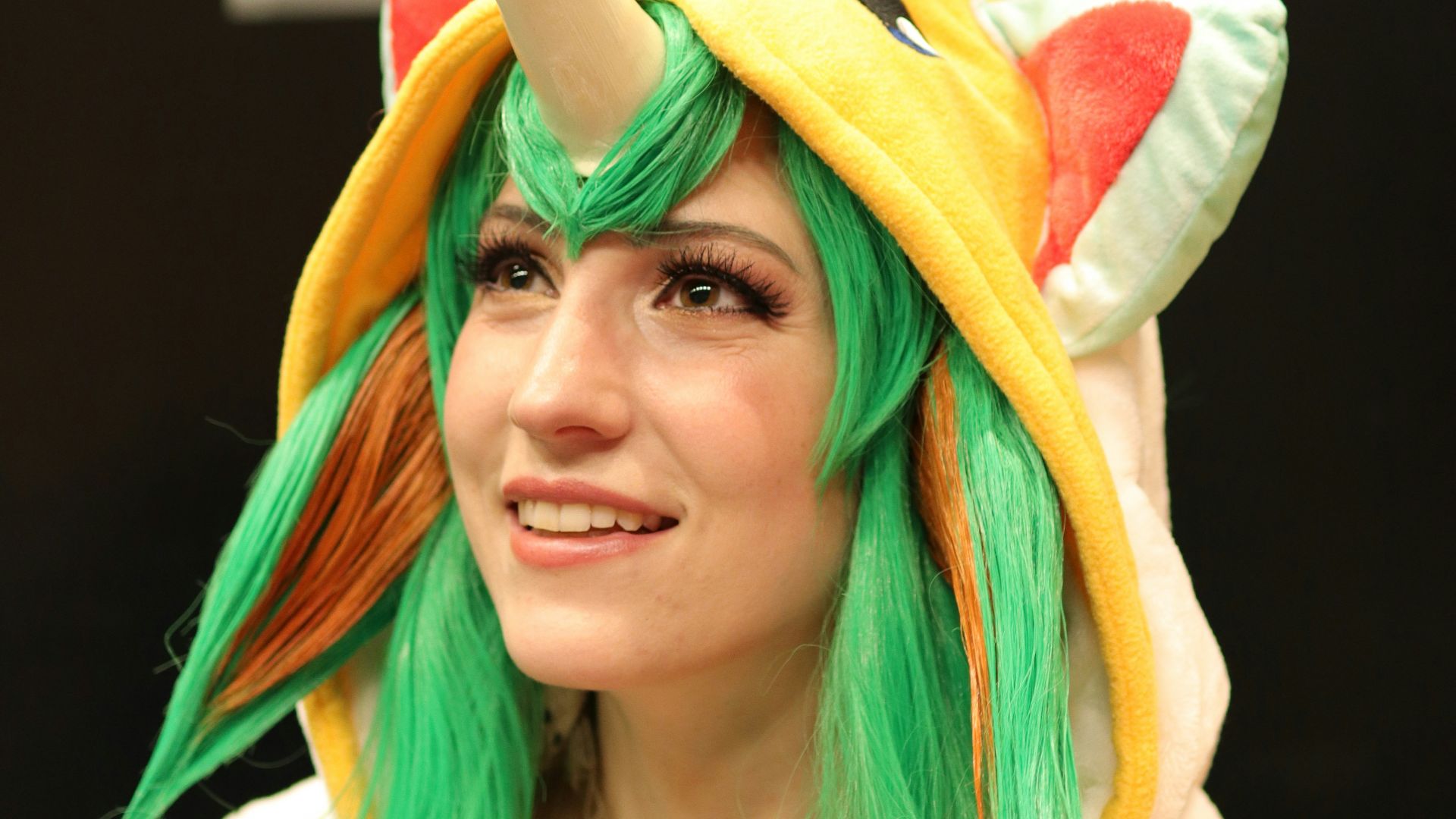 woman in white shirt with yellow and green scarf