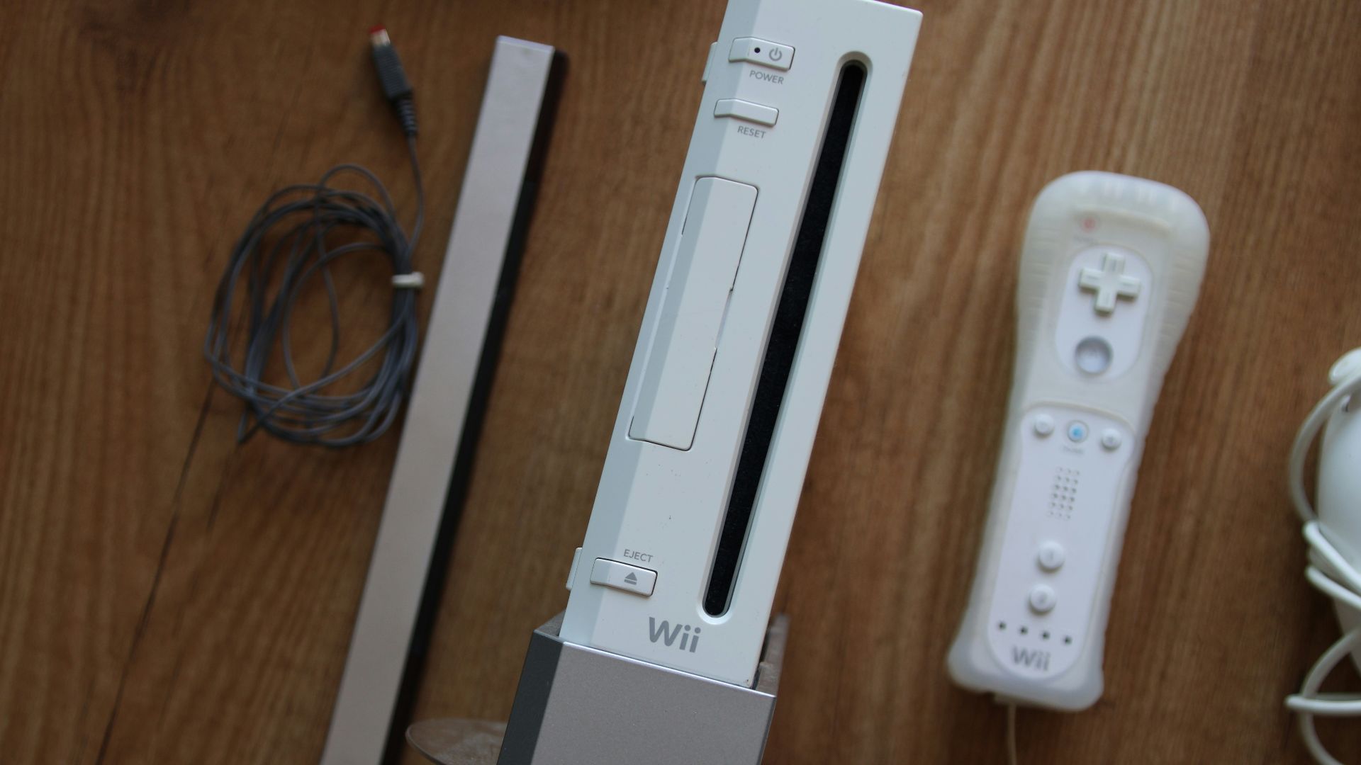 a nintendo wii game system sitting on top of a wooden table