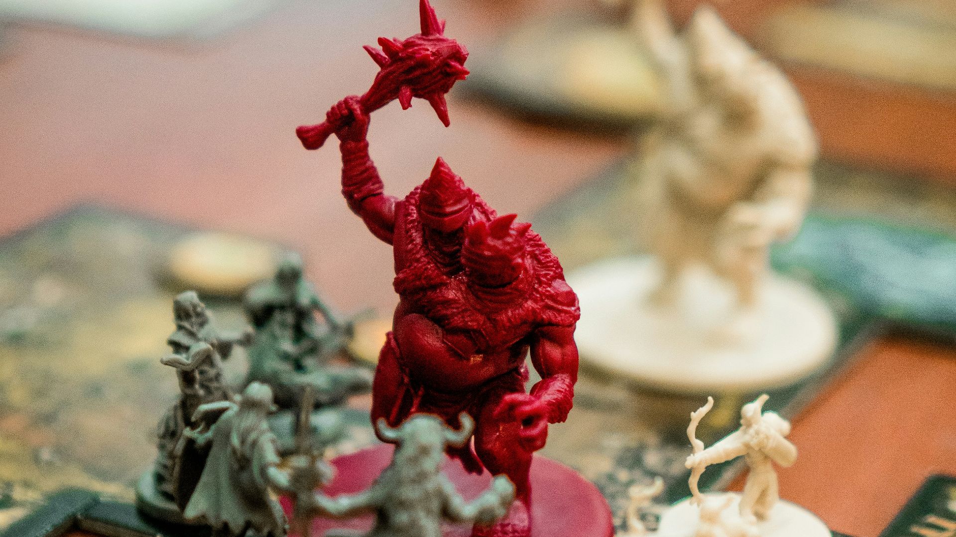 red, white, and green action figures on table
