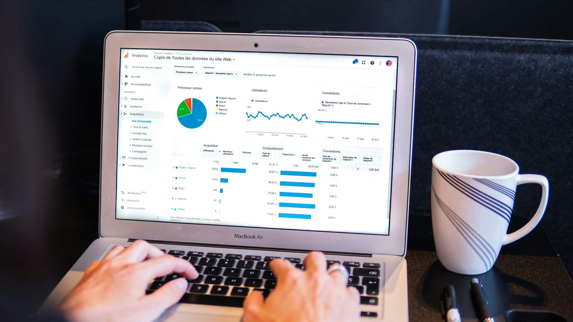 person using macbook pro on black table