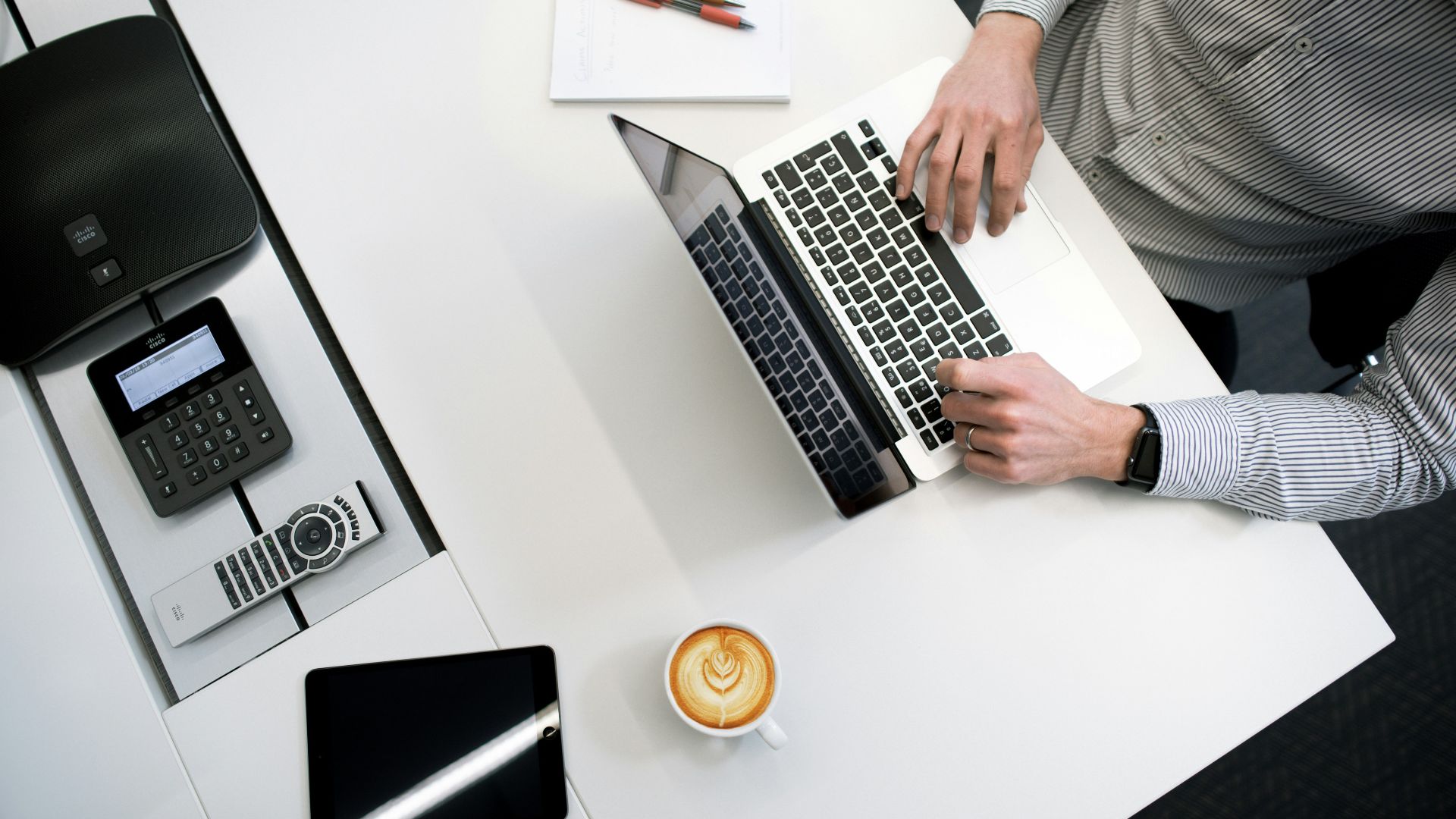 person using laptop on white wooden table