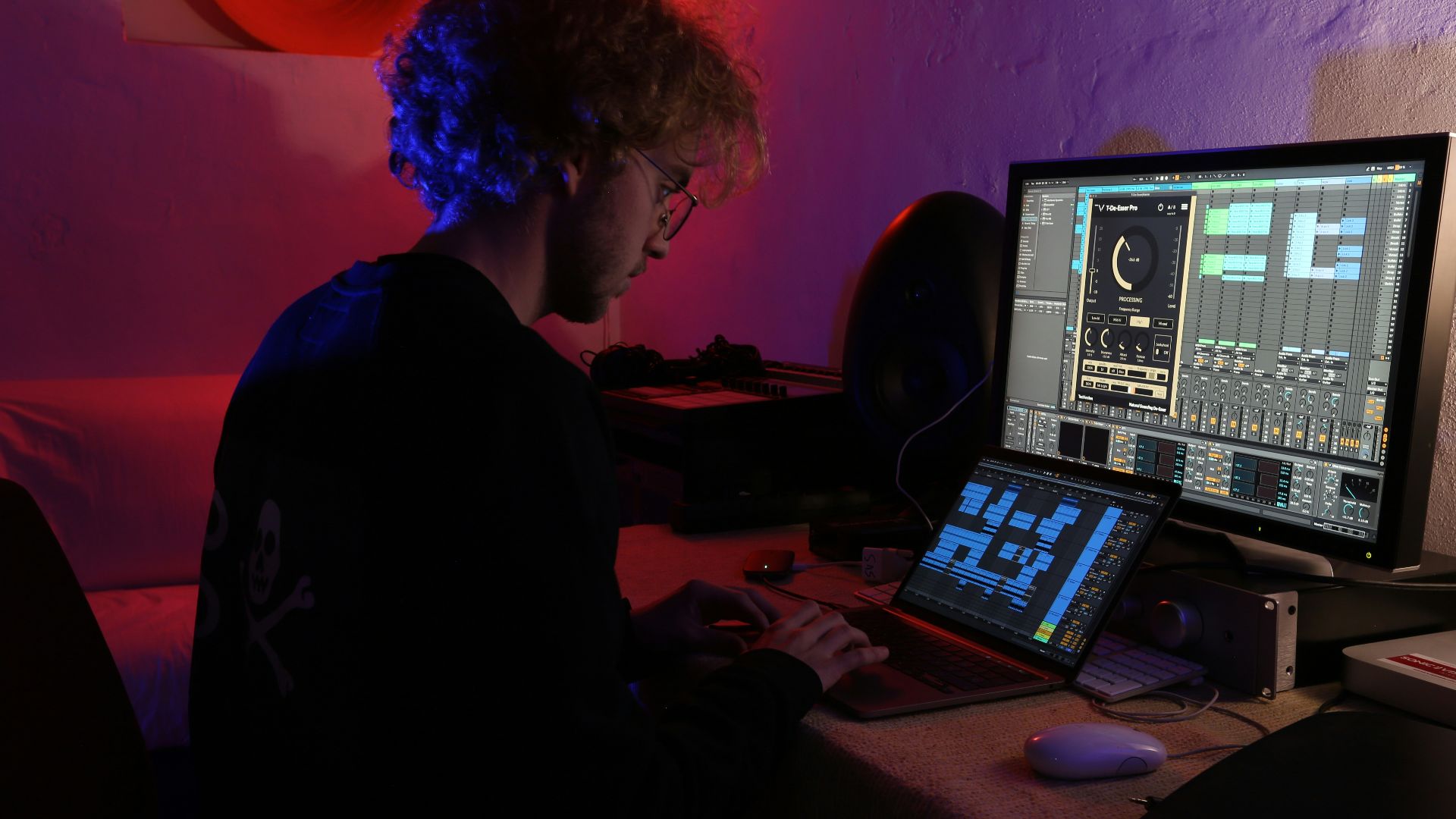a man sitting in front of a computer monitor