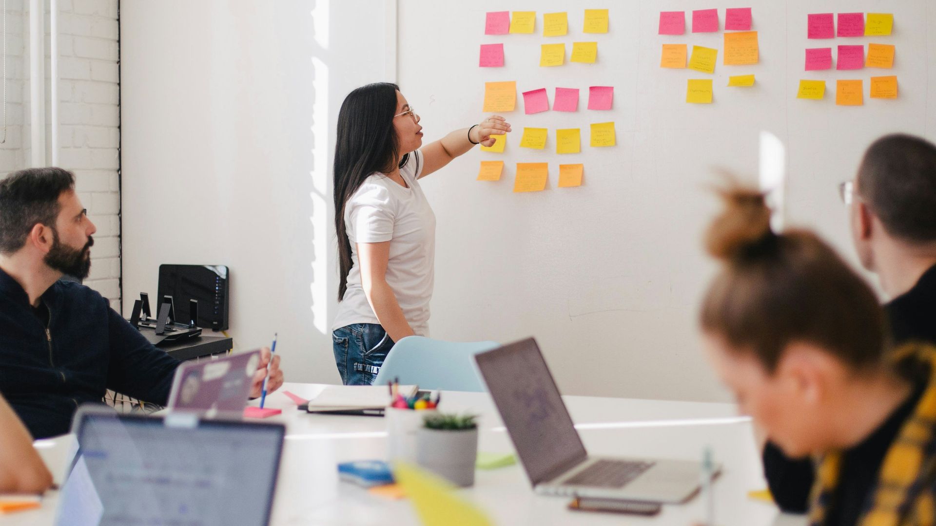 woman placing sticky notes on wall