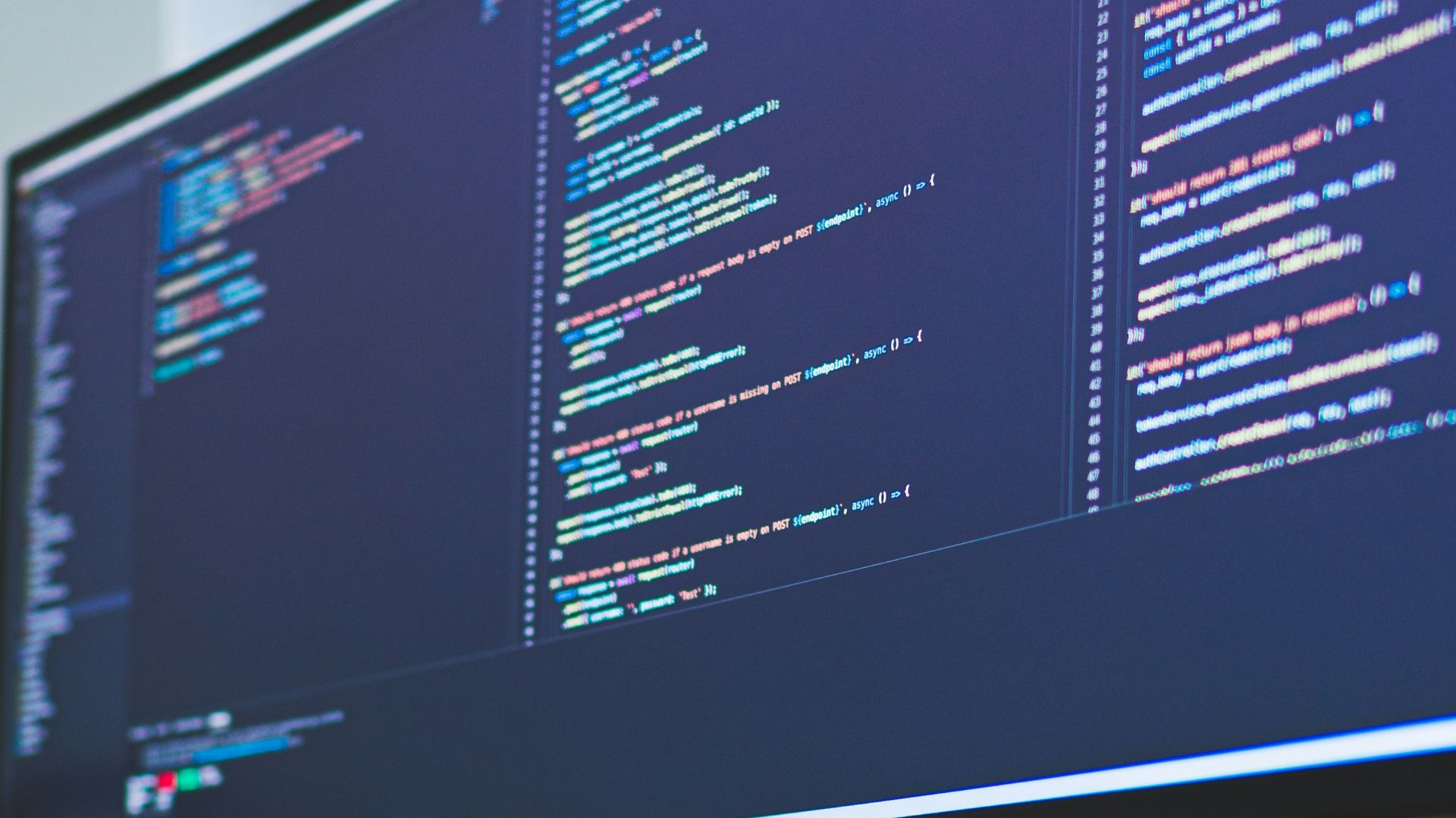 a computer monitor sitting on top of a wooden desk