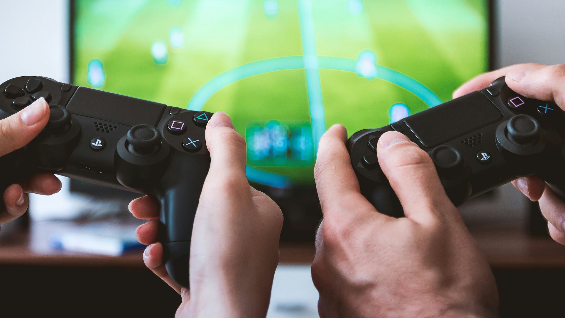 two people playing Sony PS4 game console