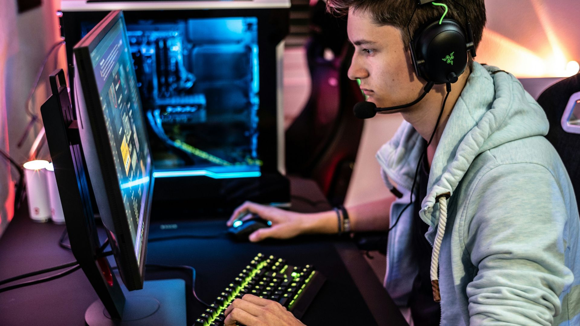 a man sitting at a computer with headphones on