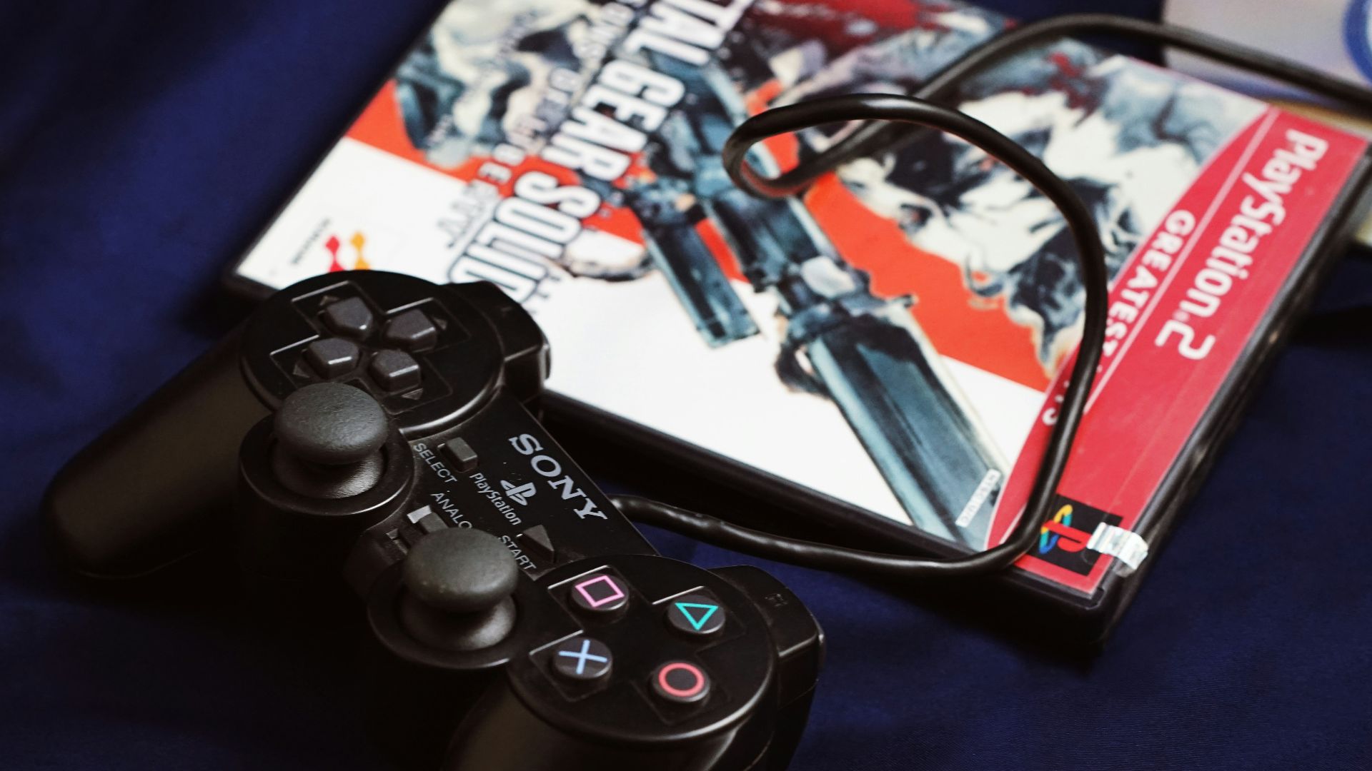 a couple of video game controllers sitting next to a dvd