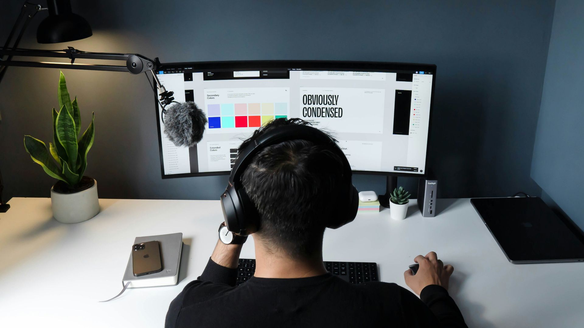man in black shirt sitting in front of computer