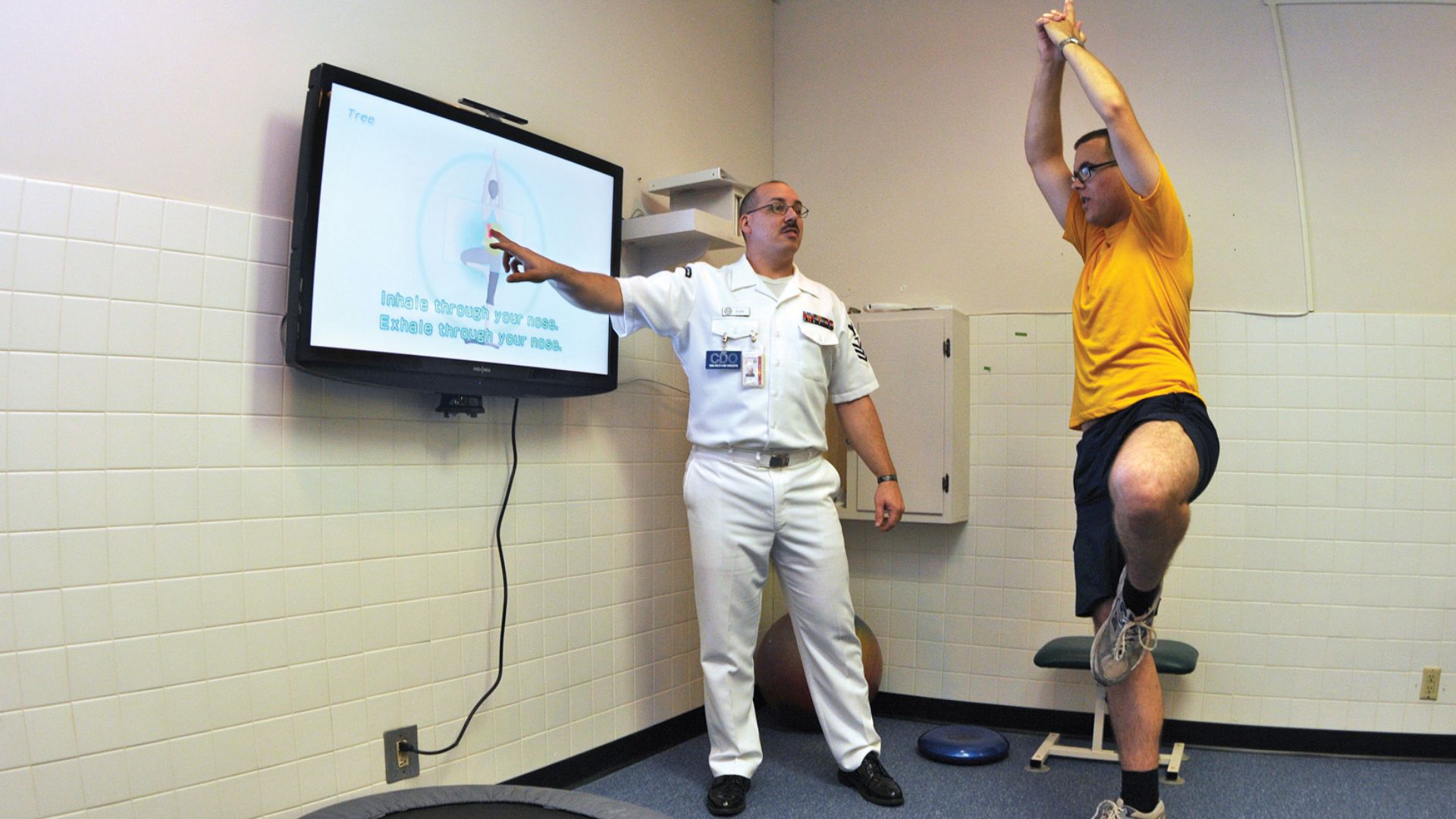 File:US Navy 090702-N-1783P-003 Hospital Corpsman 1st Class Guy Duke, left, and Electronics Technician 3rd Class Joshua Benedict demonstrate how the Physical therapy Department at Naval Health Clinic, Charleston use the Wii Fit's yoga.jpg