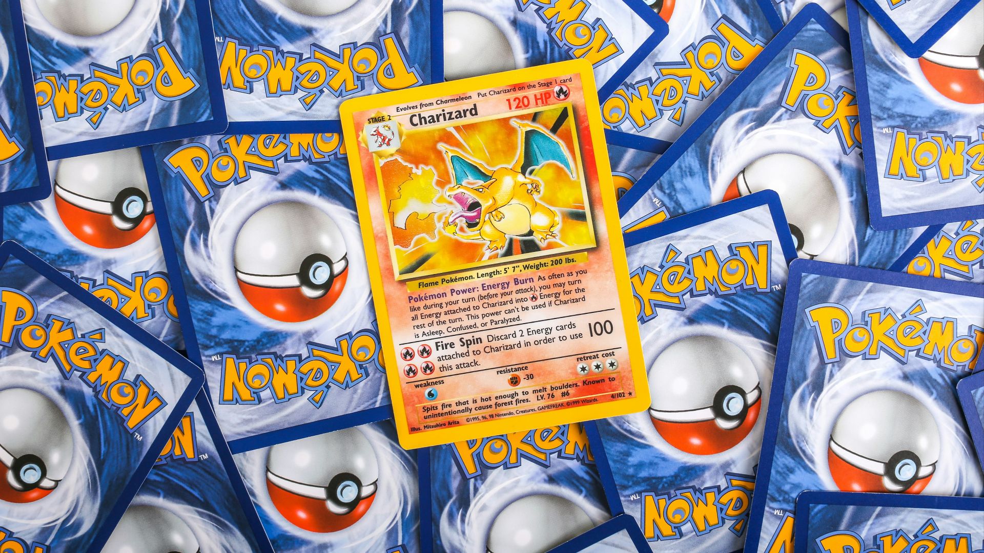 a pile of pokemon trading cards sitting on top of each other