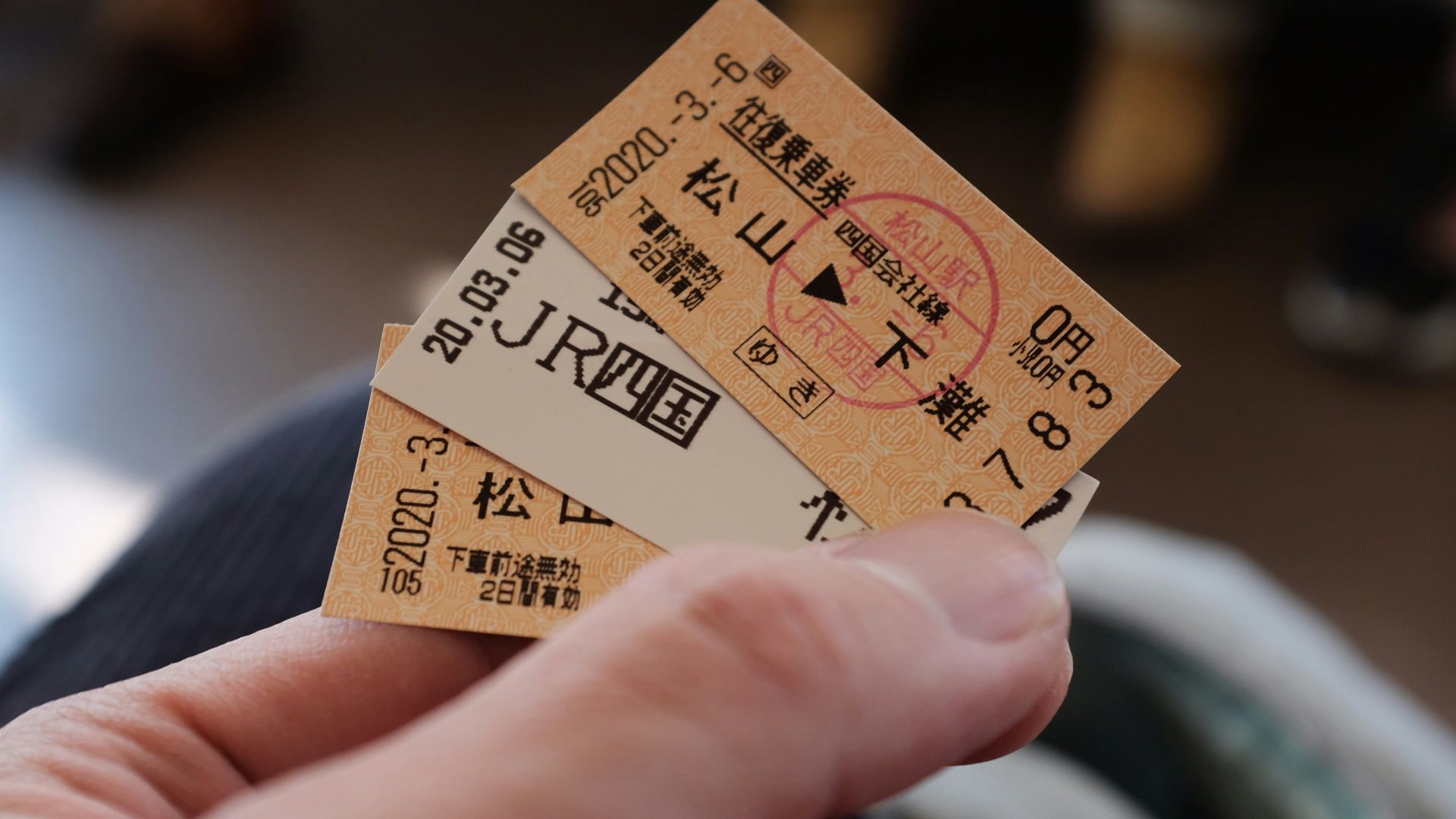 person holding brown and black card