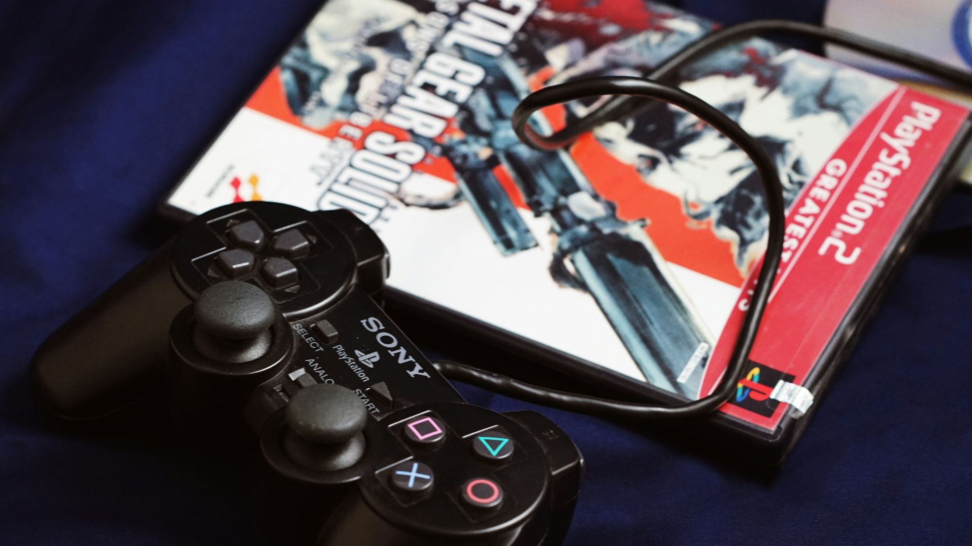 a couple of video game controllers sitting next to a dvd