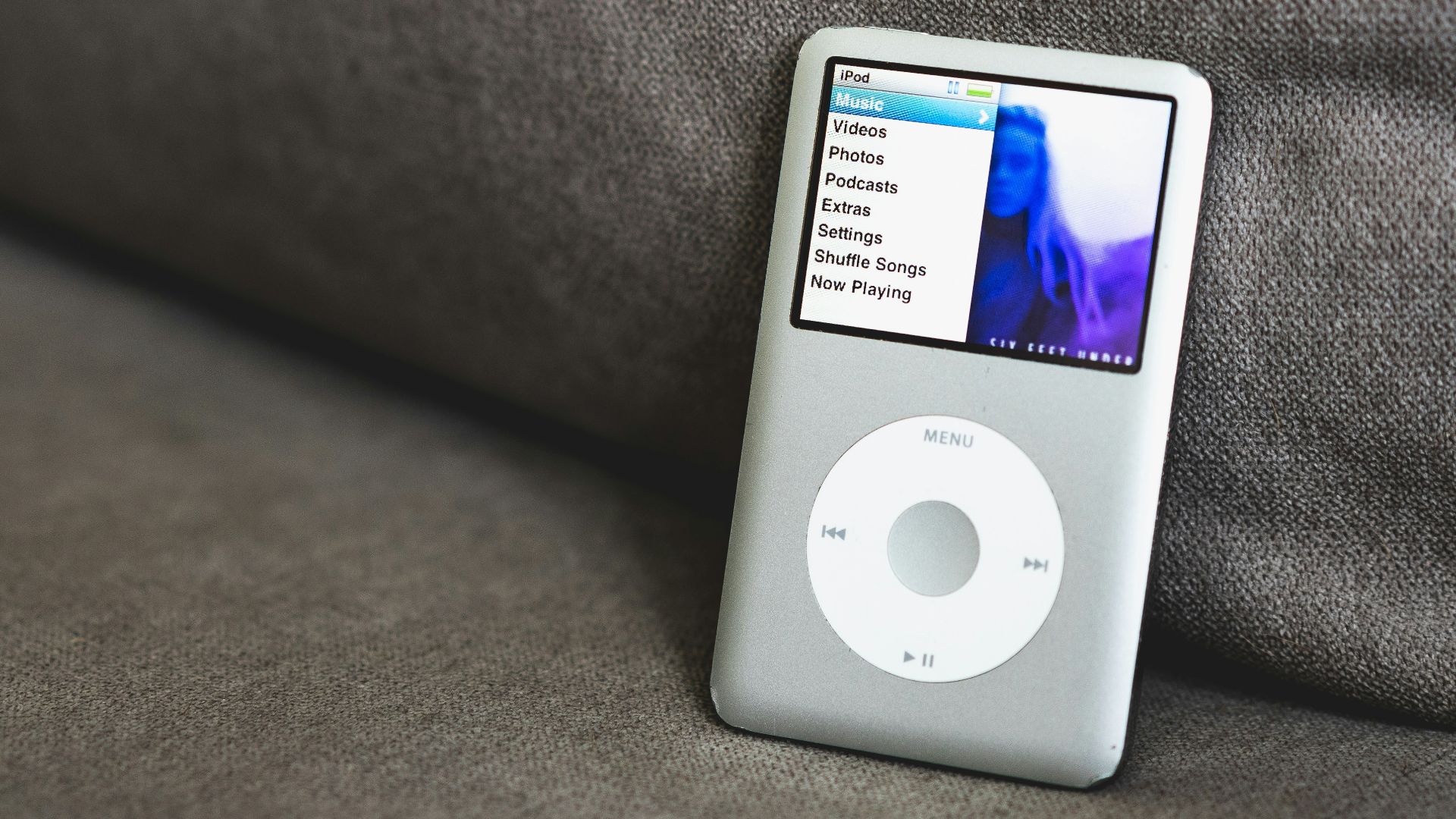 an ipod sitting on top of a couch