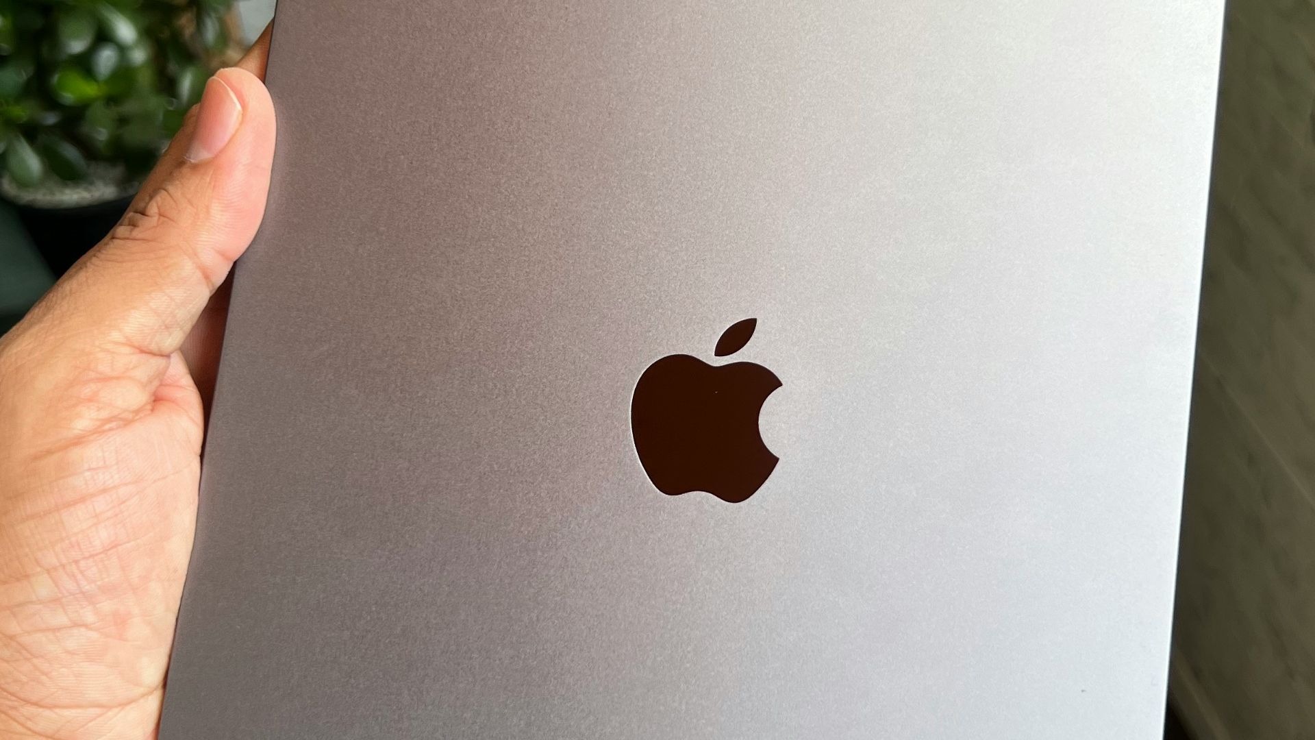 a person holding an apple ipad in their hand