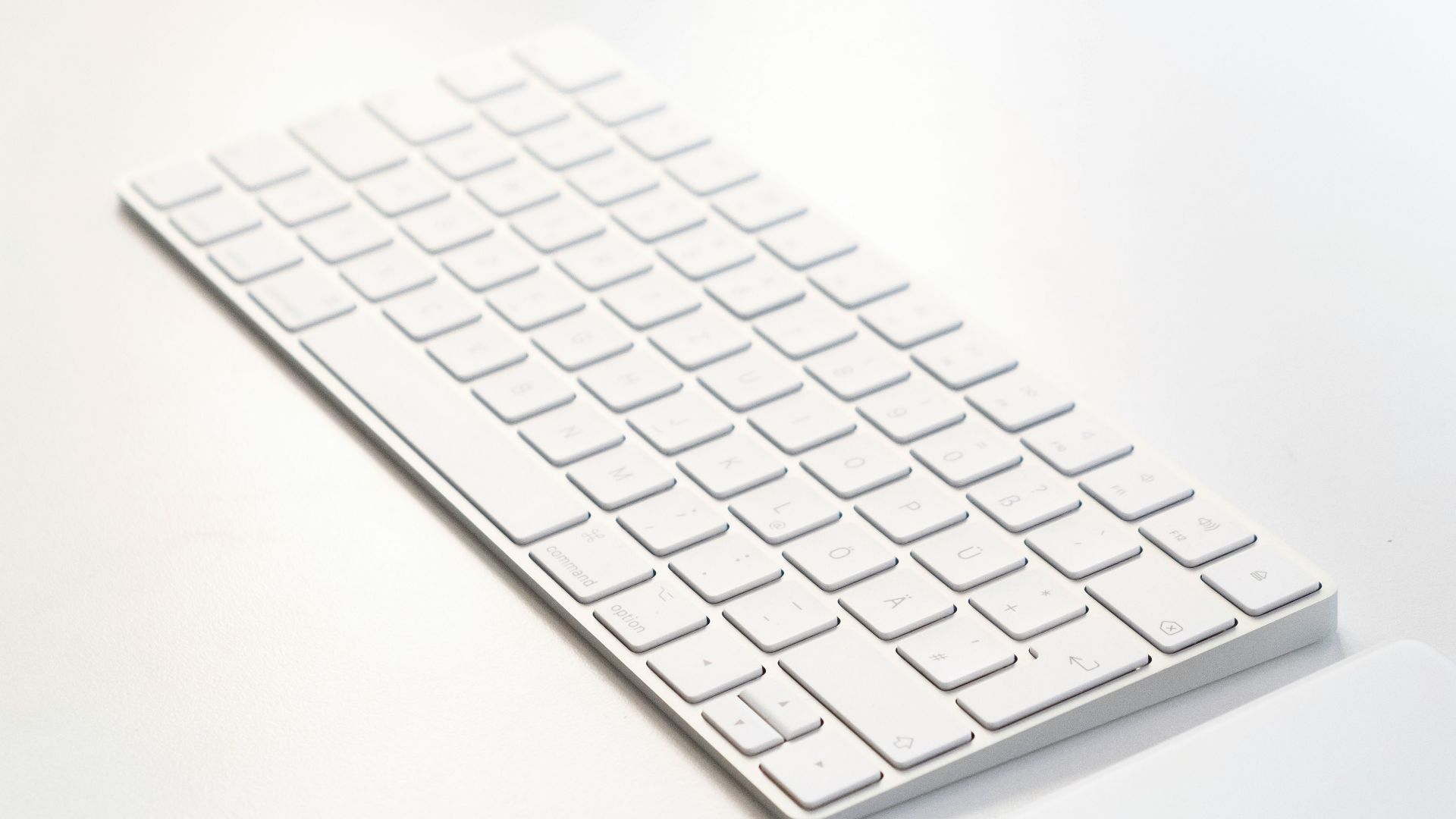 white apple keyboard on white table
