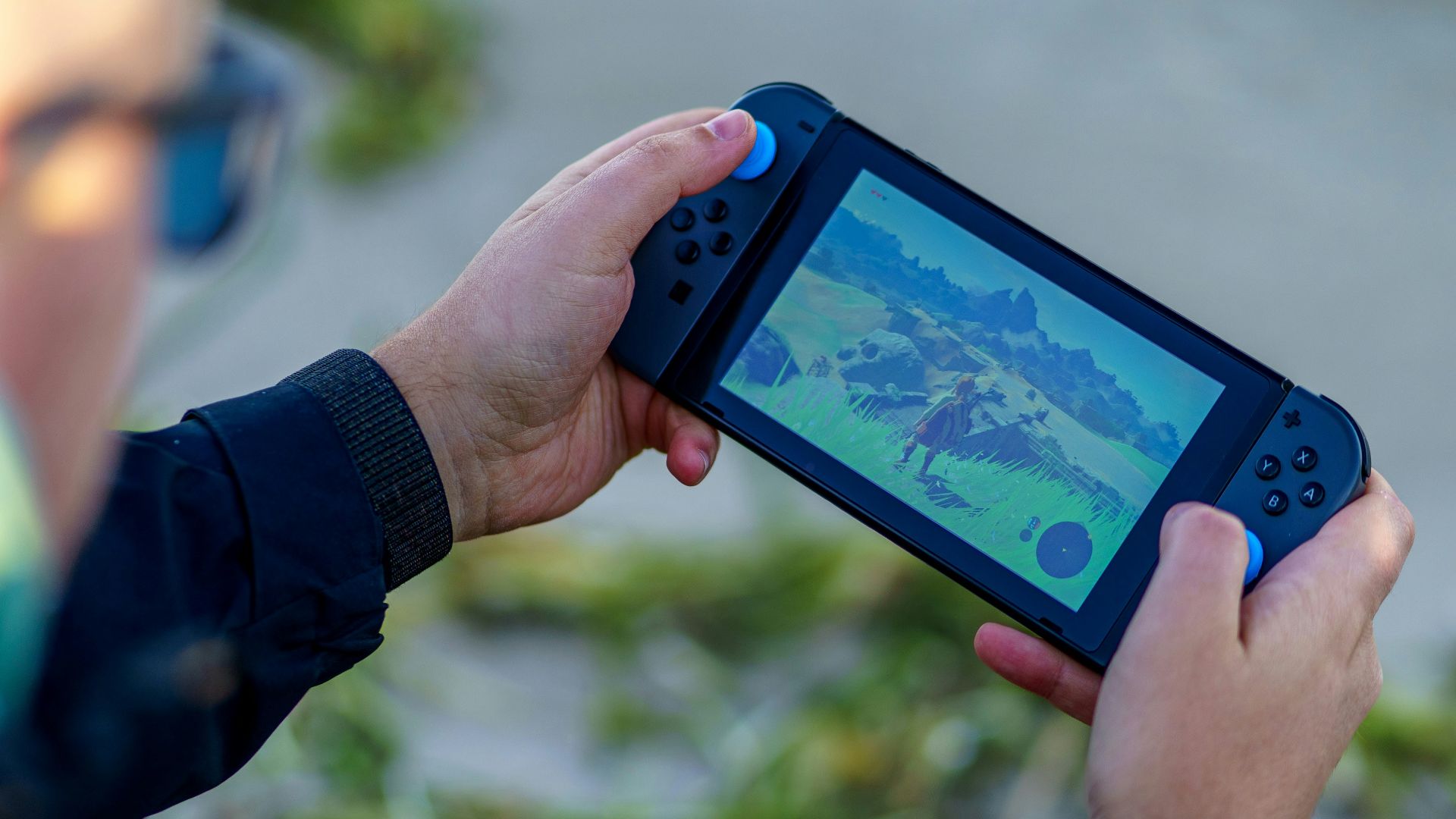 a person is playing a video game on a cell phone