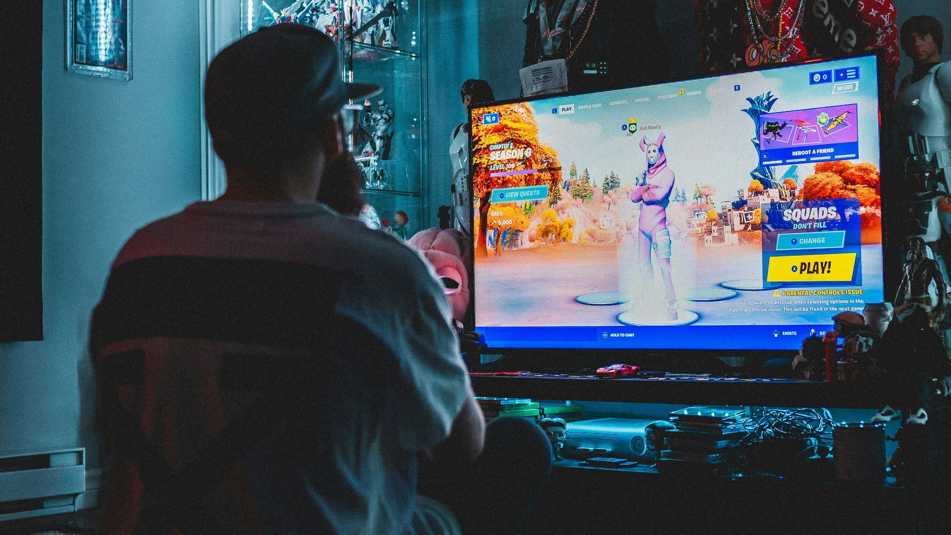 man in red shirt watching tv