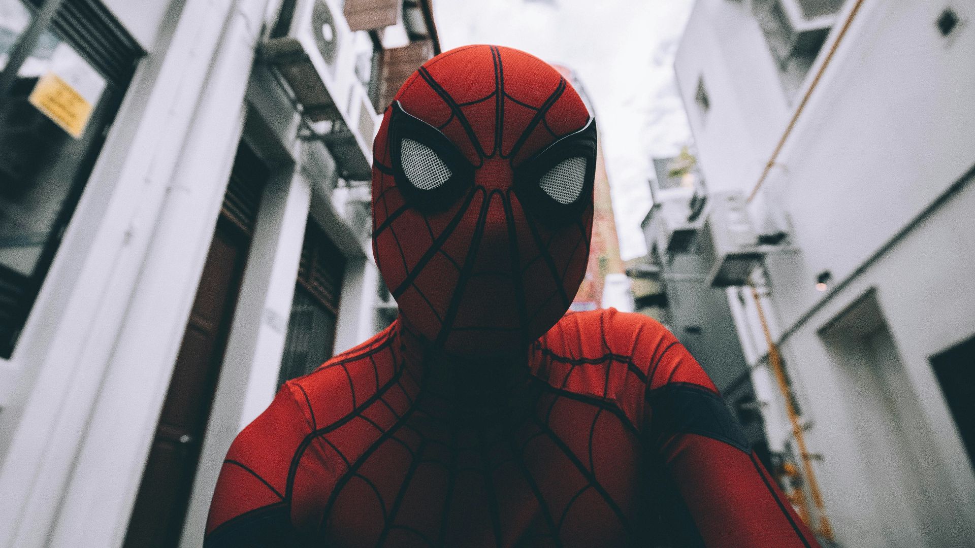 Spider-Man standing in the middle of buildings