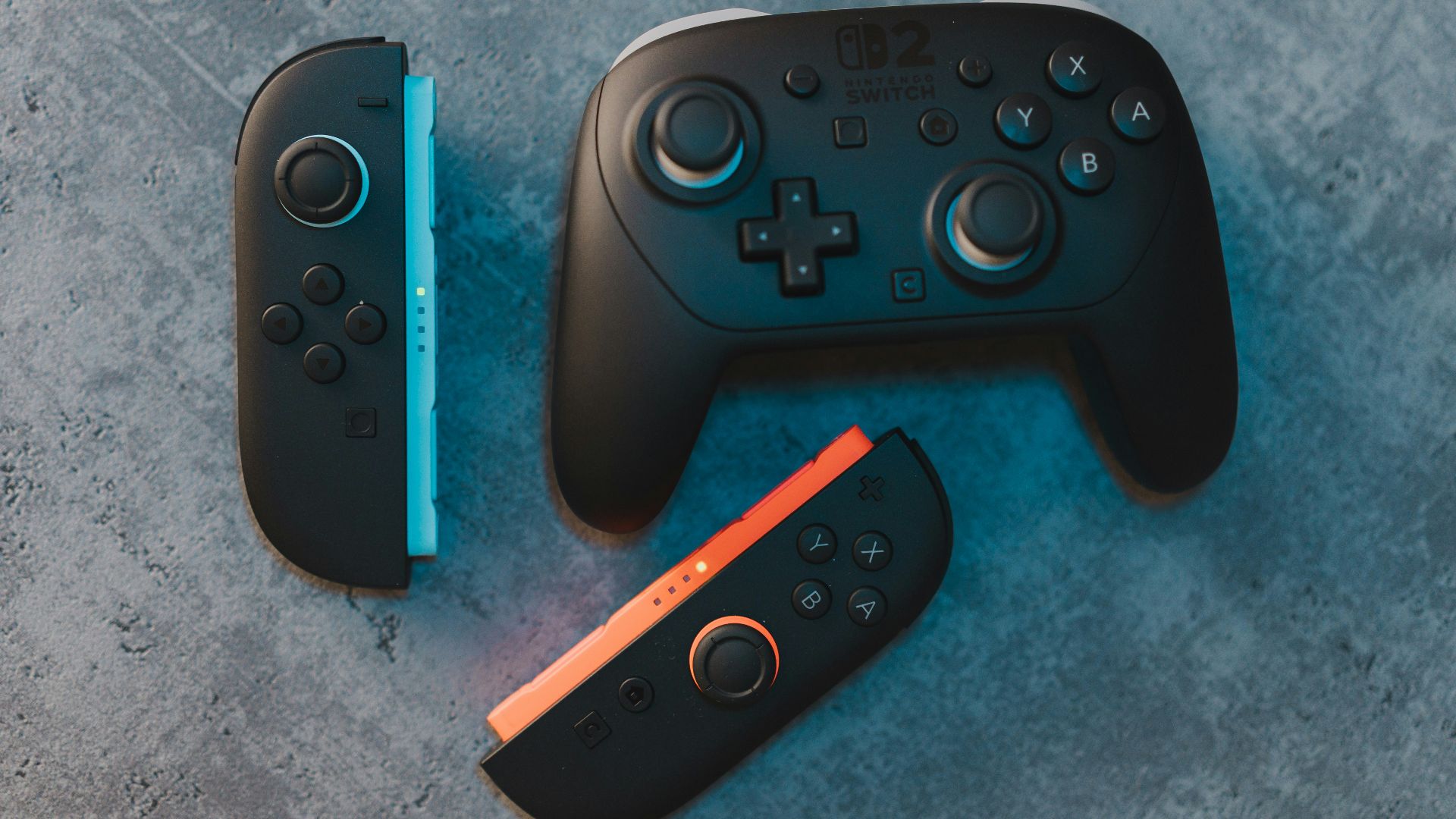 Different nintendo switch controllers on a surface.