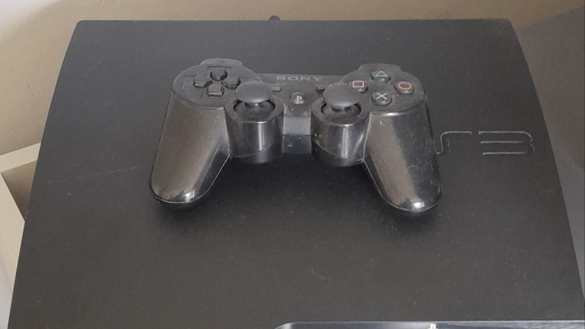 File:PS3 slim with a sixaxis controller.jpg