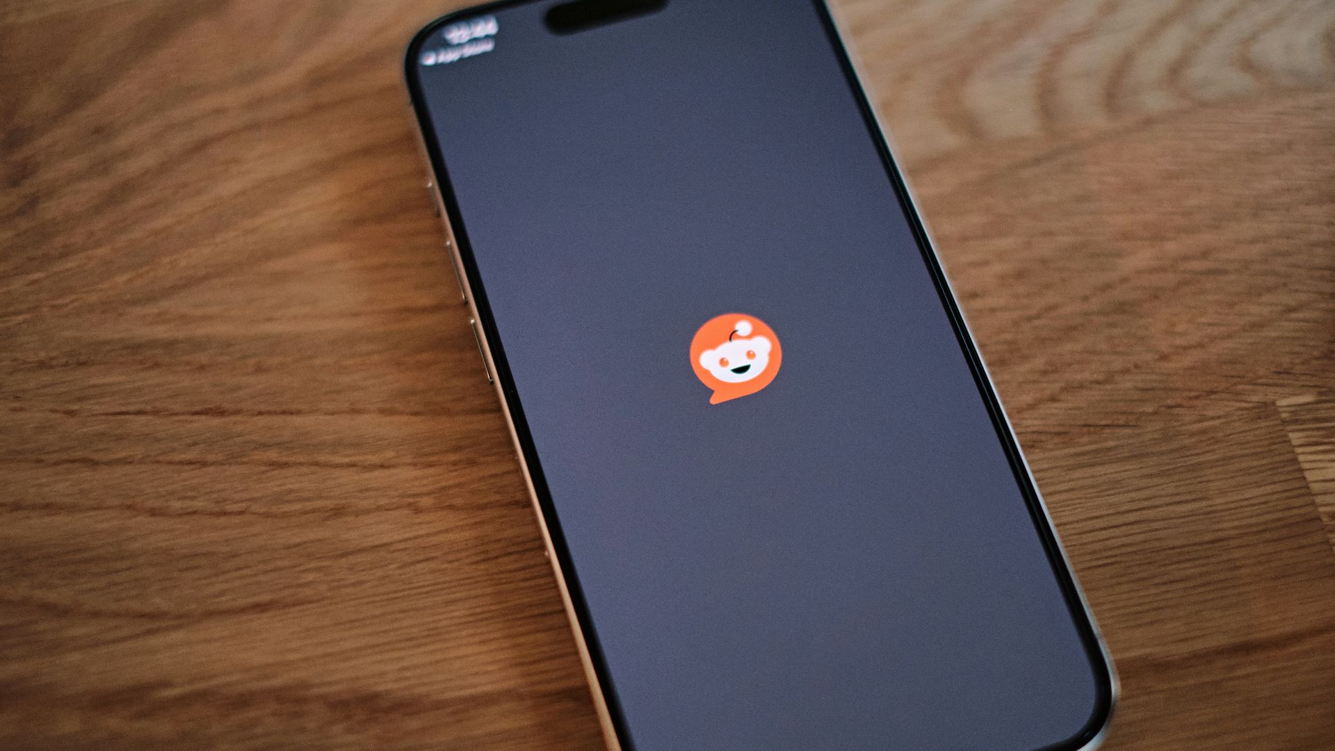 A cell phone sitting on top of a wooden table