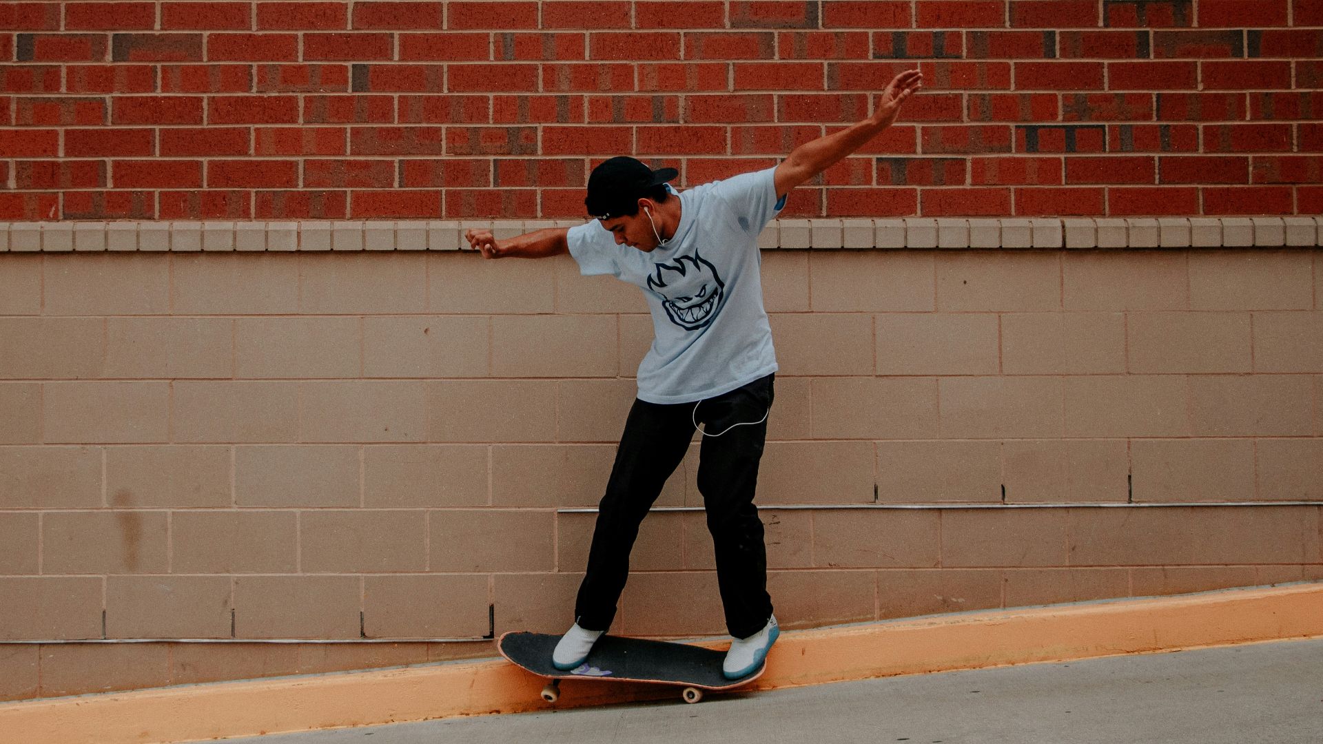 man doing skateboard tricks on sidewalk
