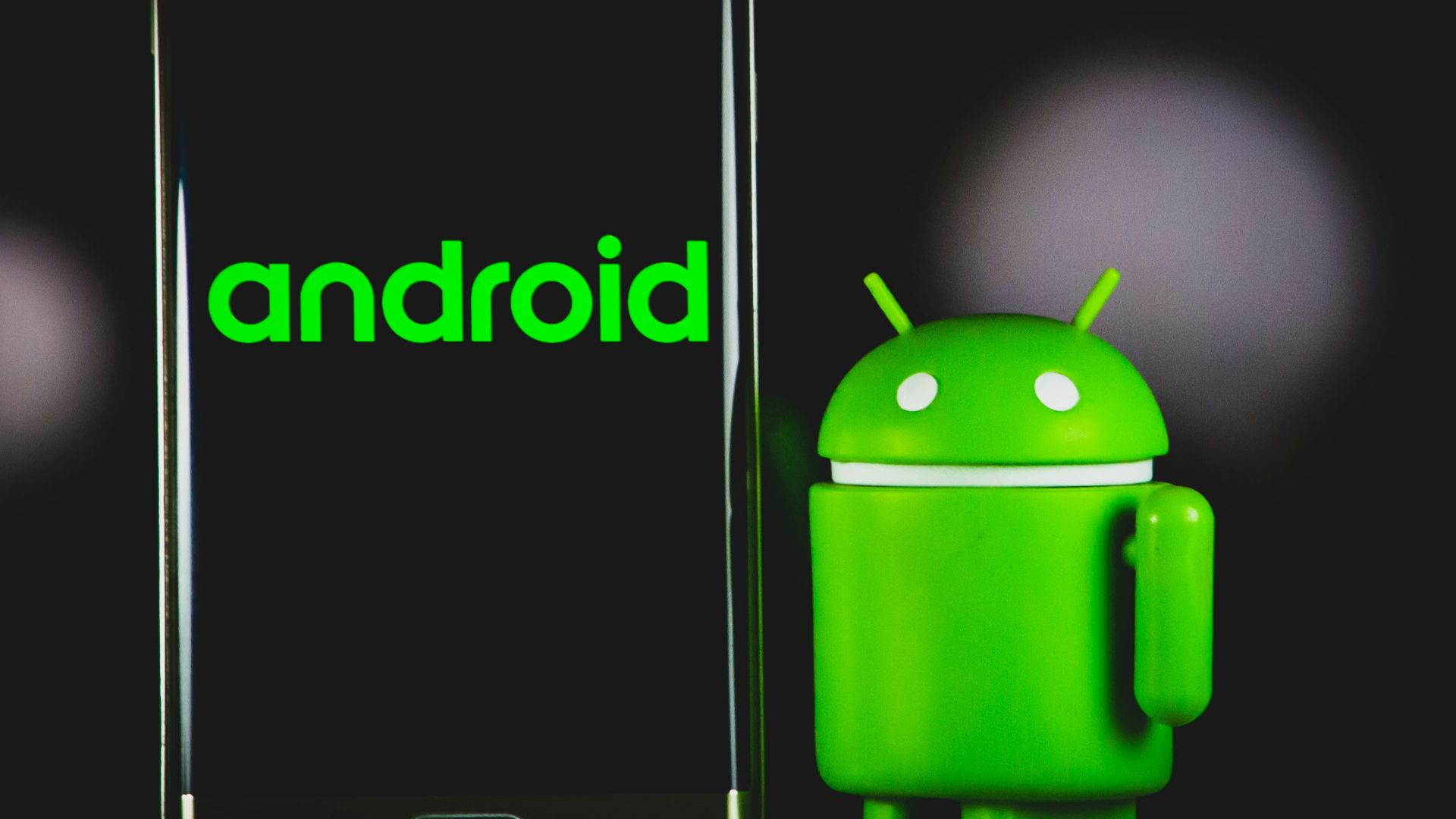 green frog iphone case beside black samsung android smartphone