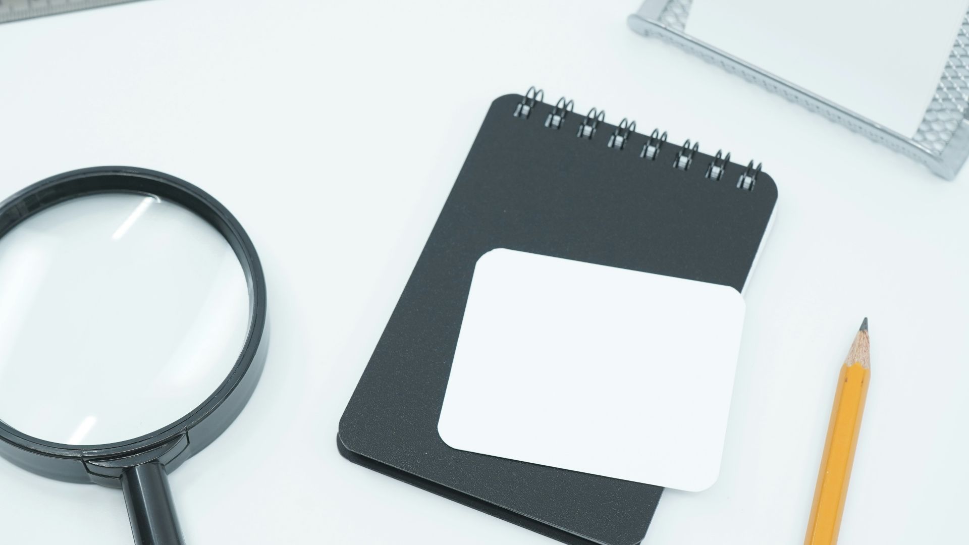 black magnifying glass on white paper