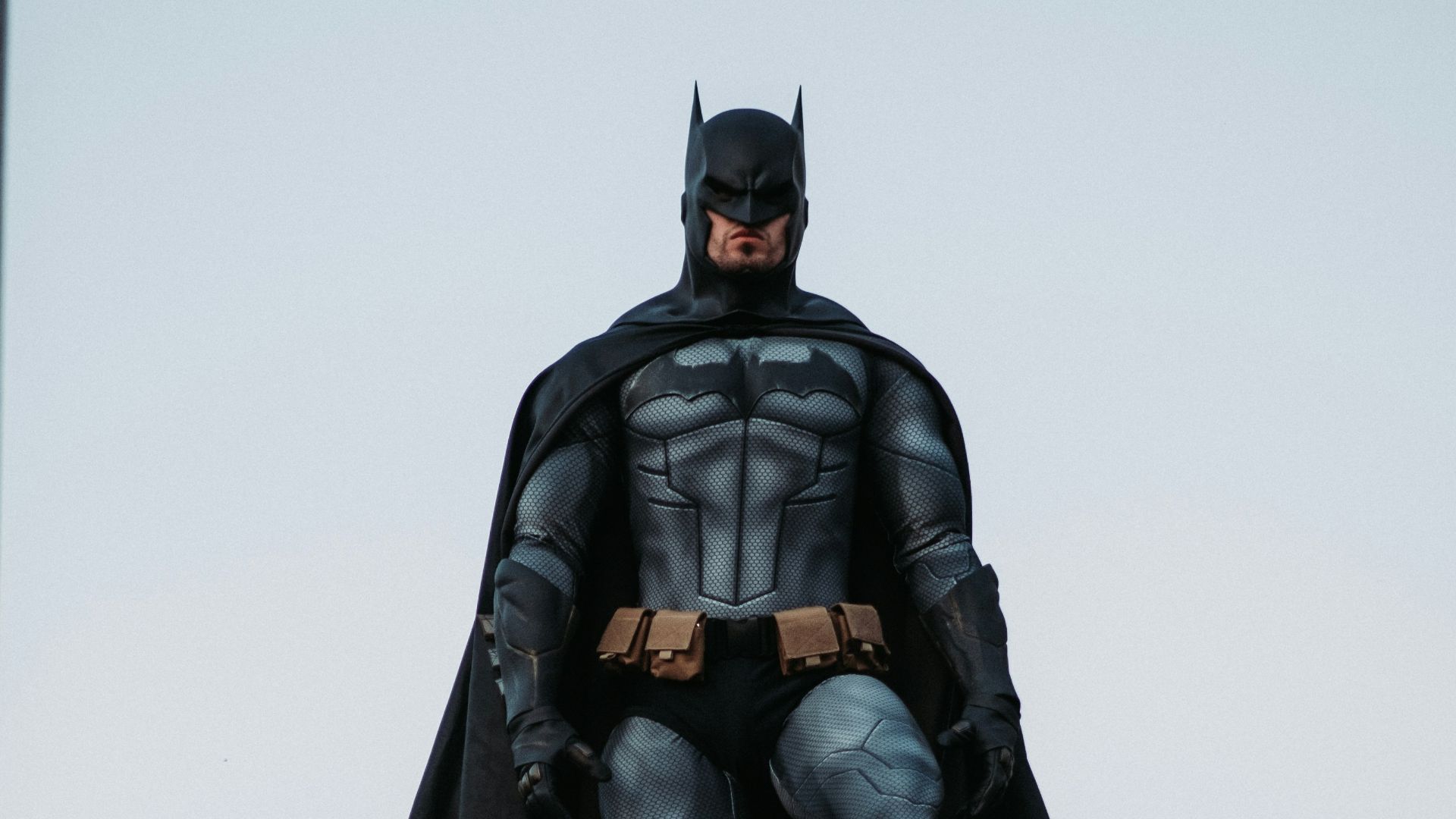 man in black jacket and pants standing on roof