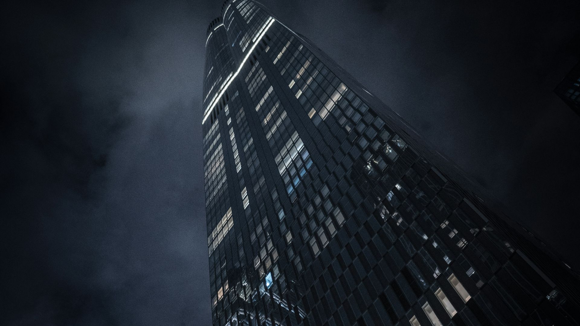 a very tall building in the middle of a city at night