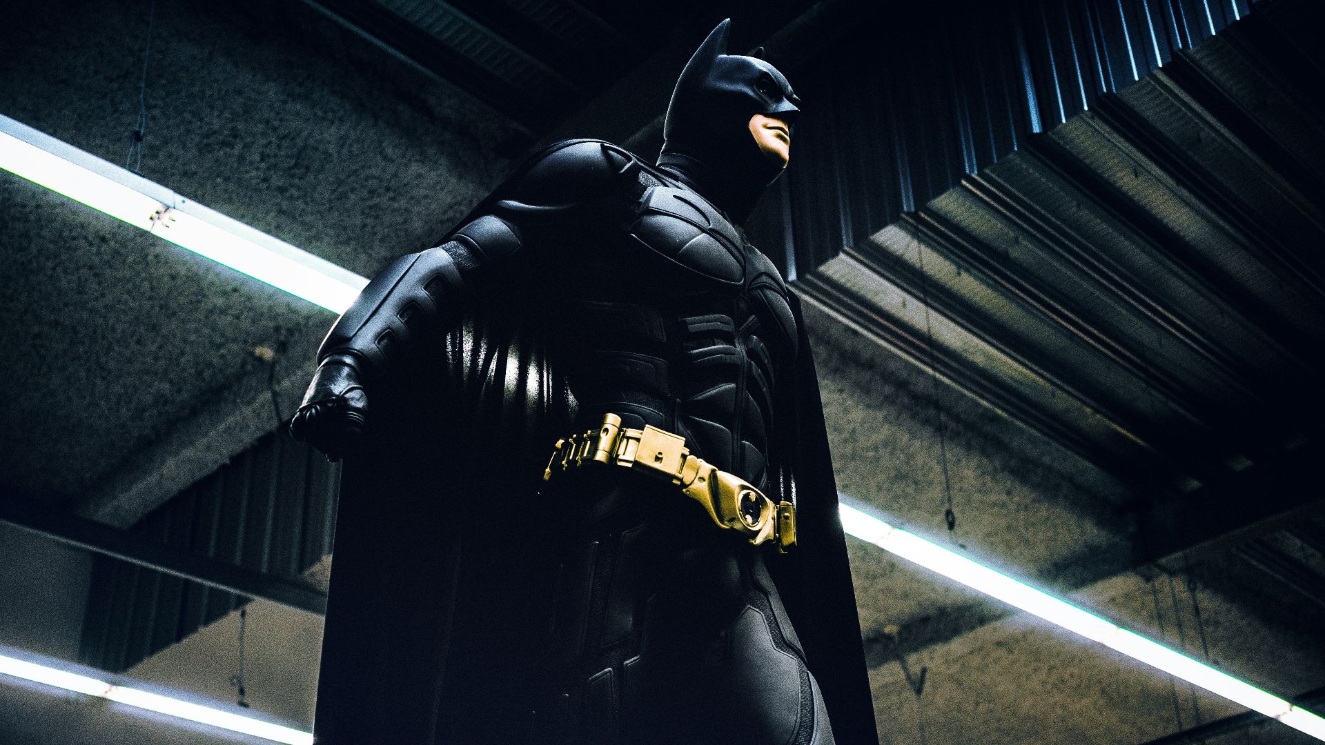 Batman standing under steel roof