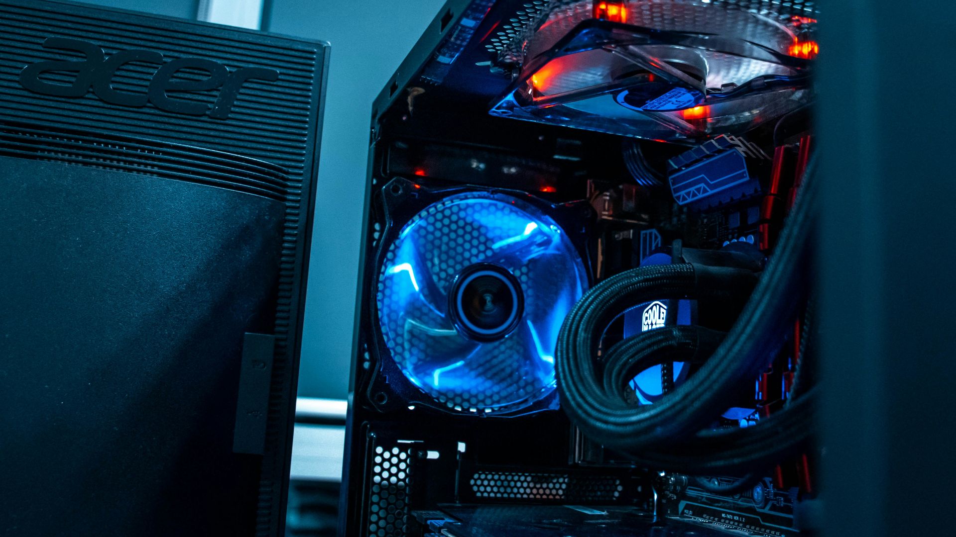 computer tower beside black Acer monitor