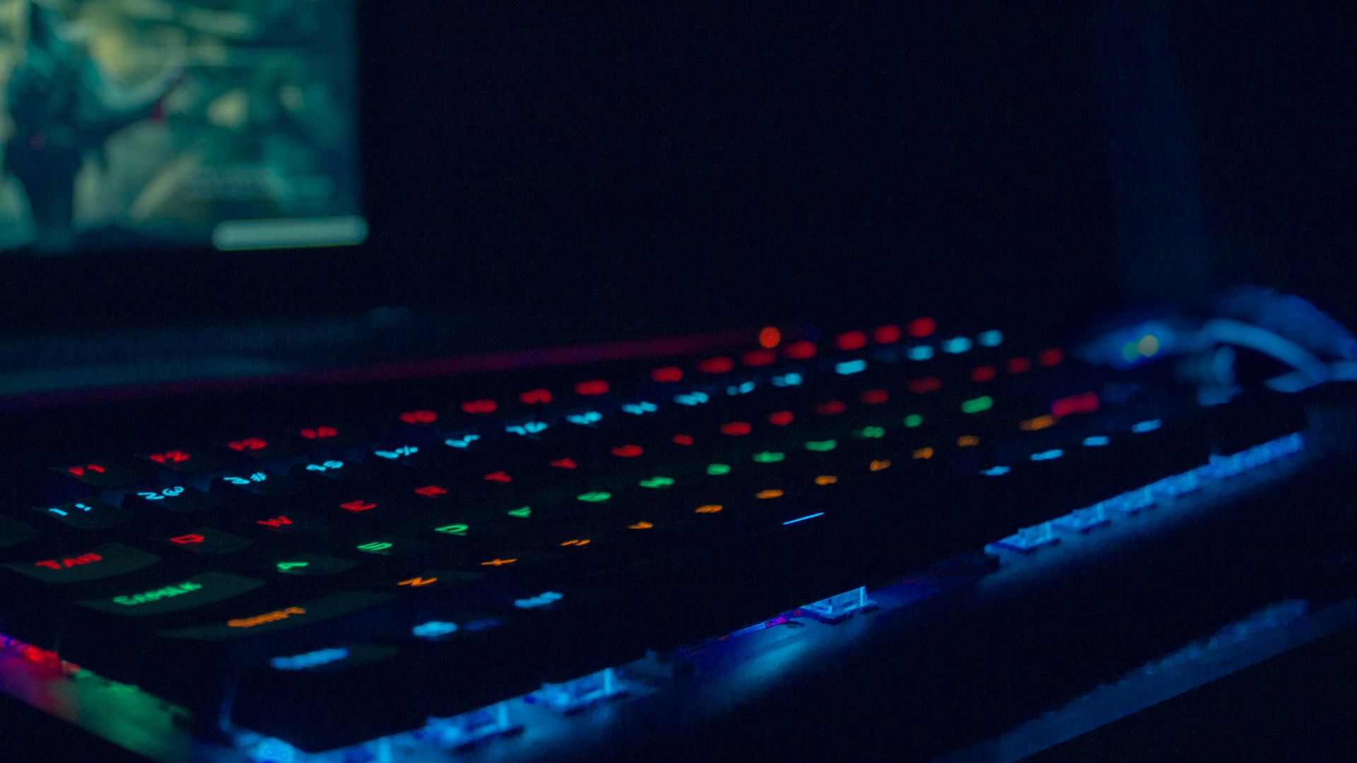 black laptop computer turned on with blue lights