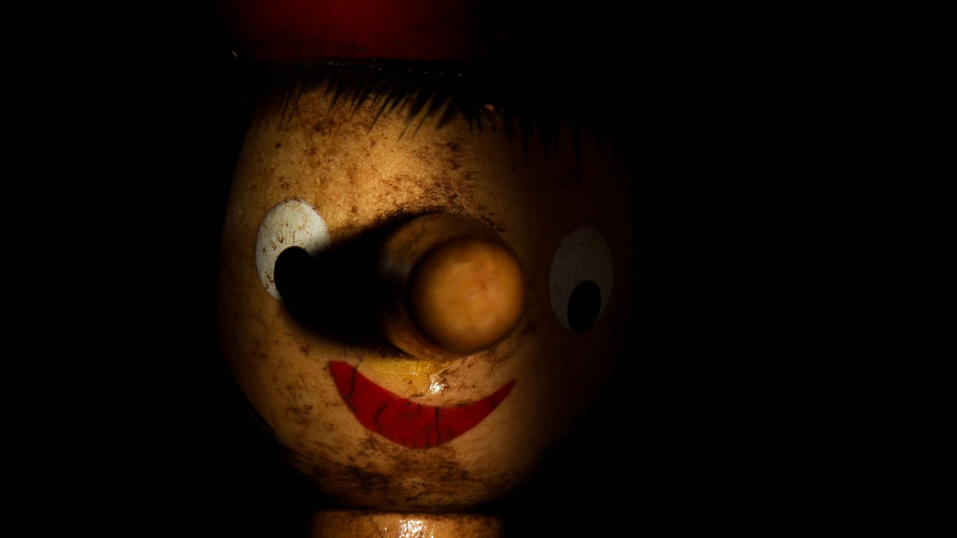 a close up of a wooden toy on a black background