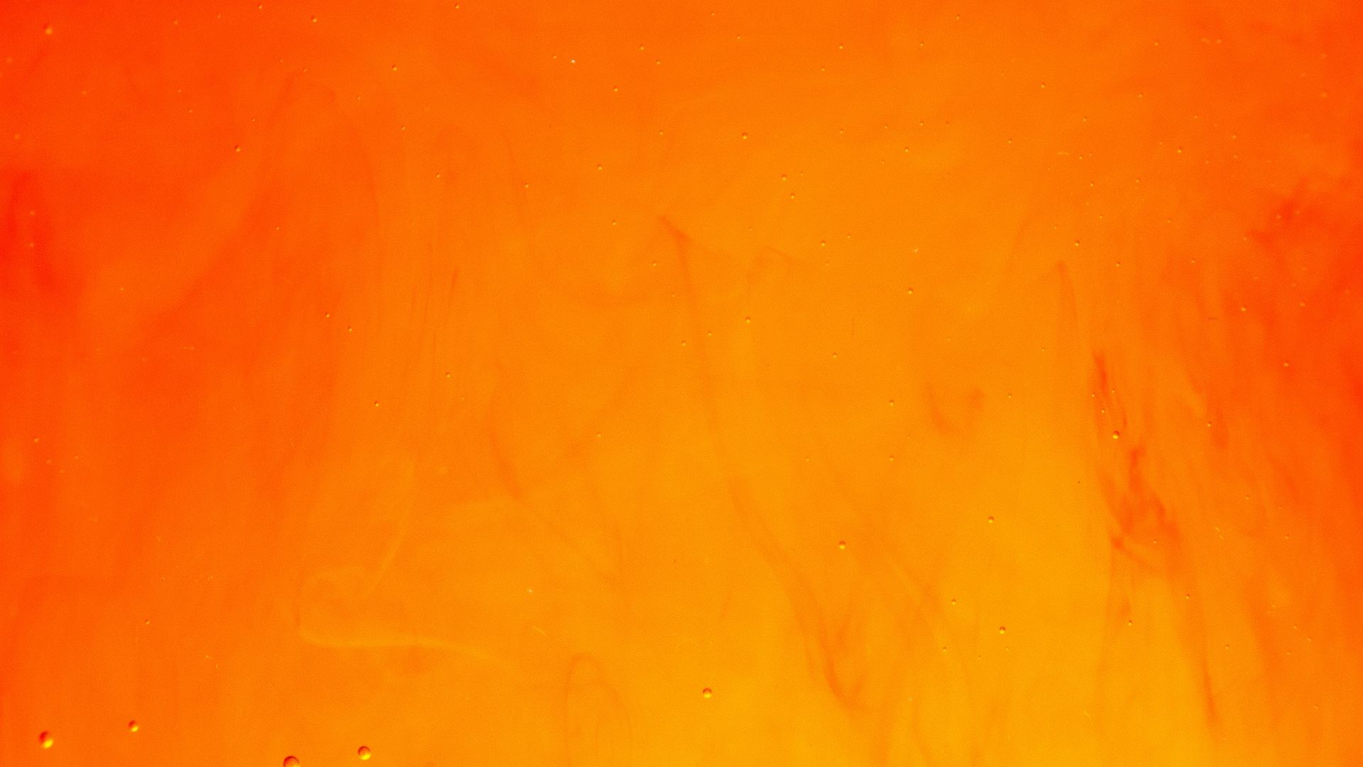 a close up of a fire with water drops on it