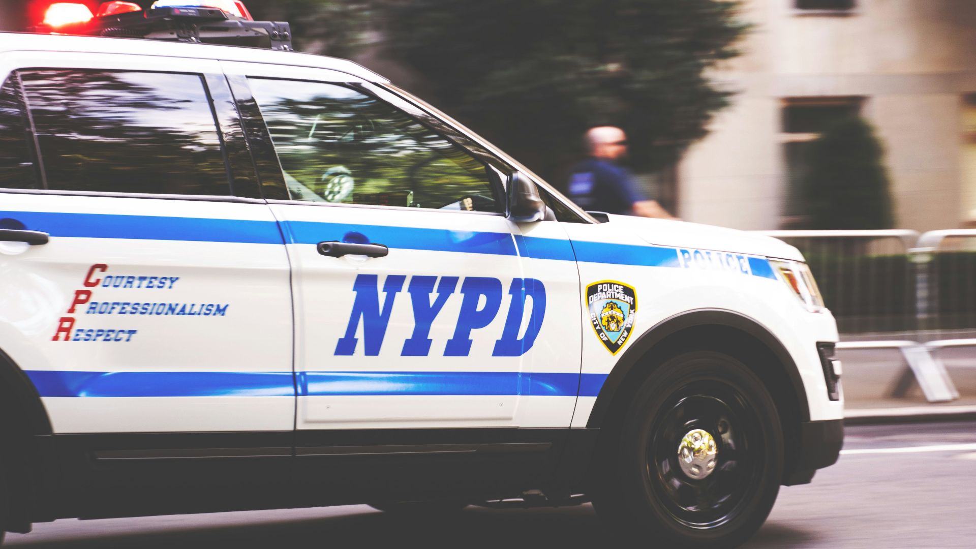 white and blue NYPD SUV