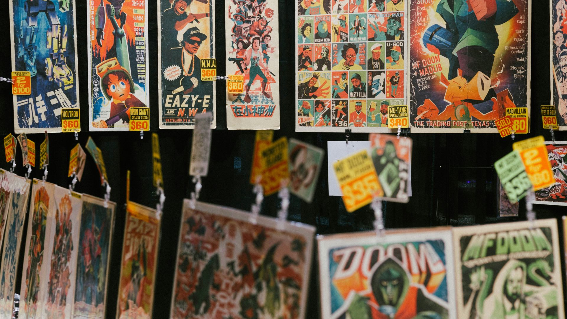 a bunch of posters hanging on a wall