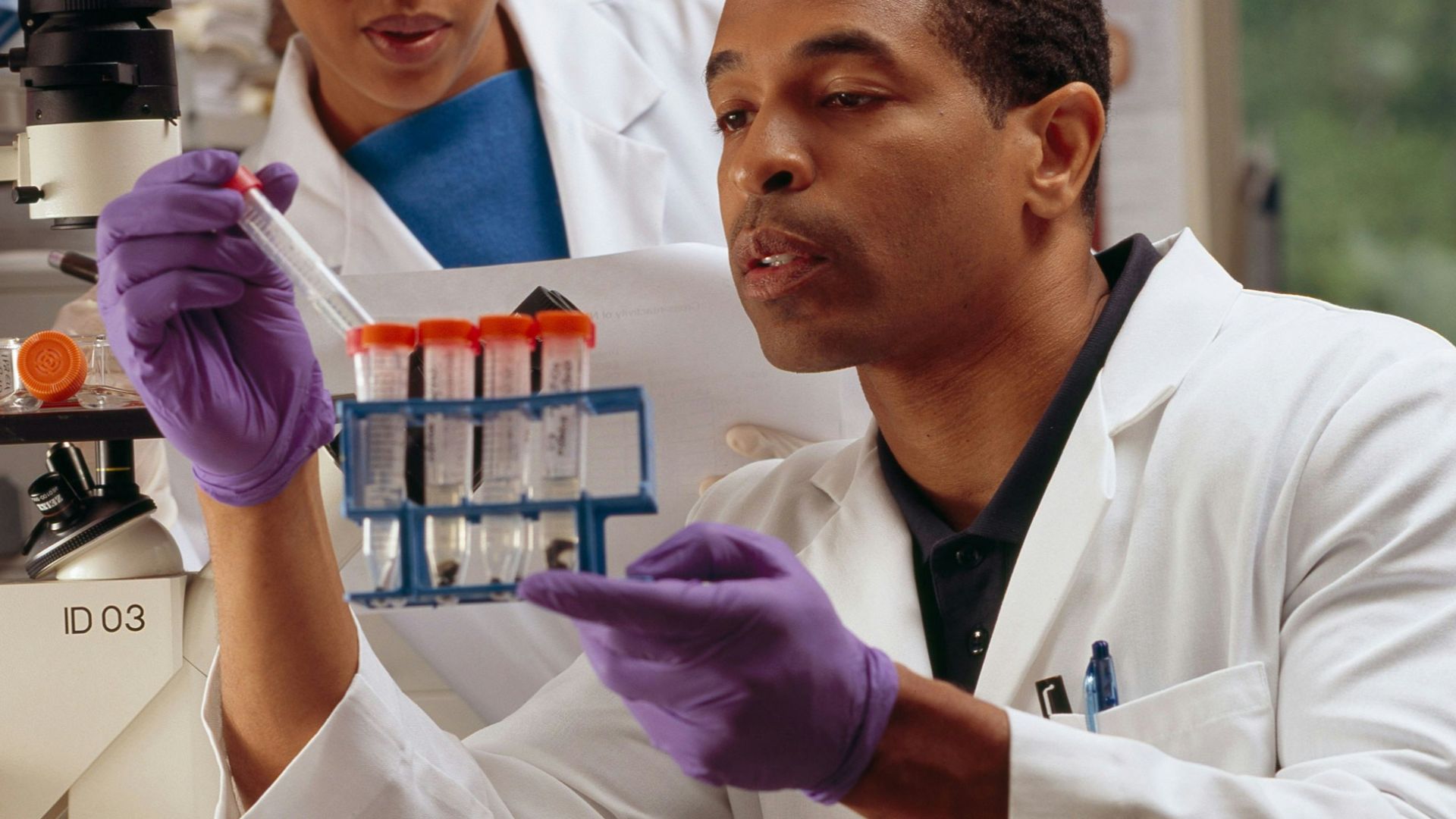 man in white chef uniform holding purple plastic bottle