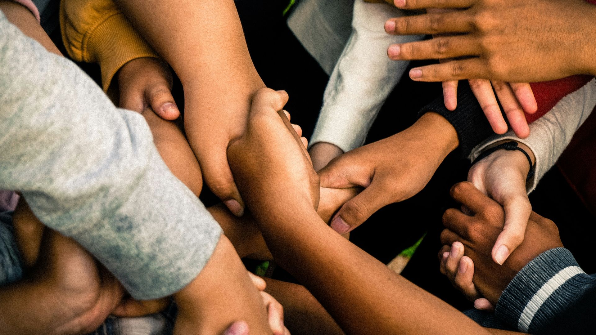 a group of people holding hands