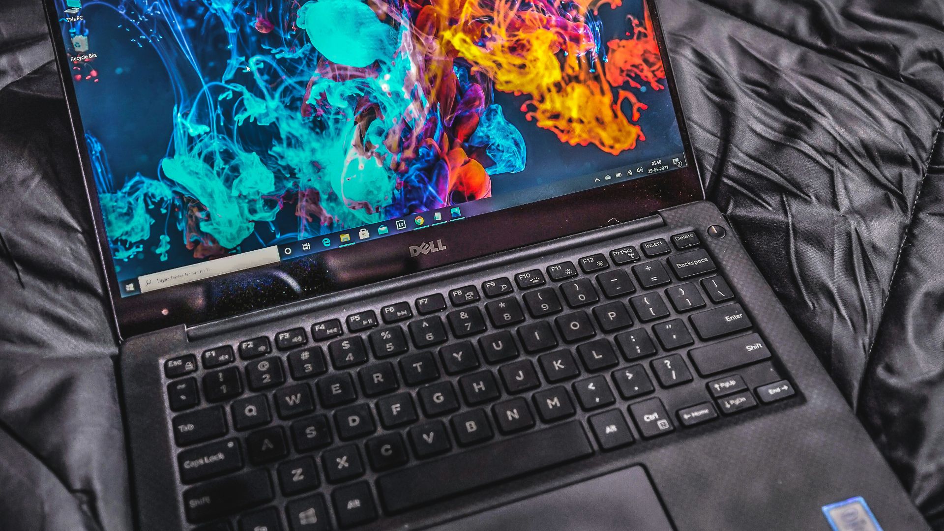 a laptop computer sitting on top of a bed