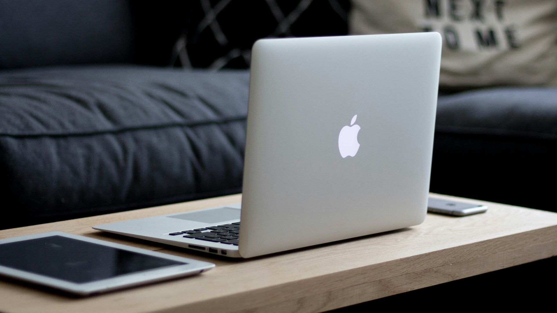 MacBook Air on brown wooden center table