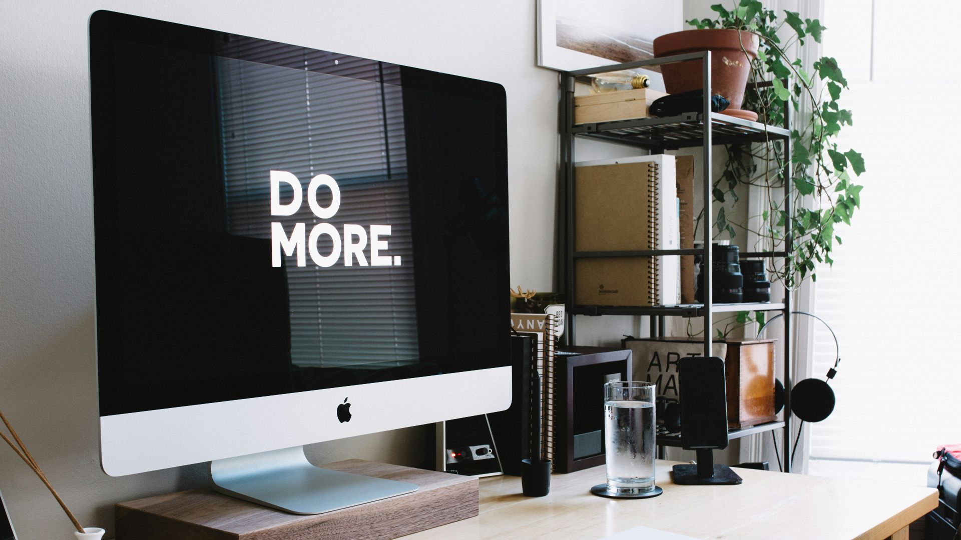 silver iMac with keyboard and trackpad inside room