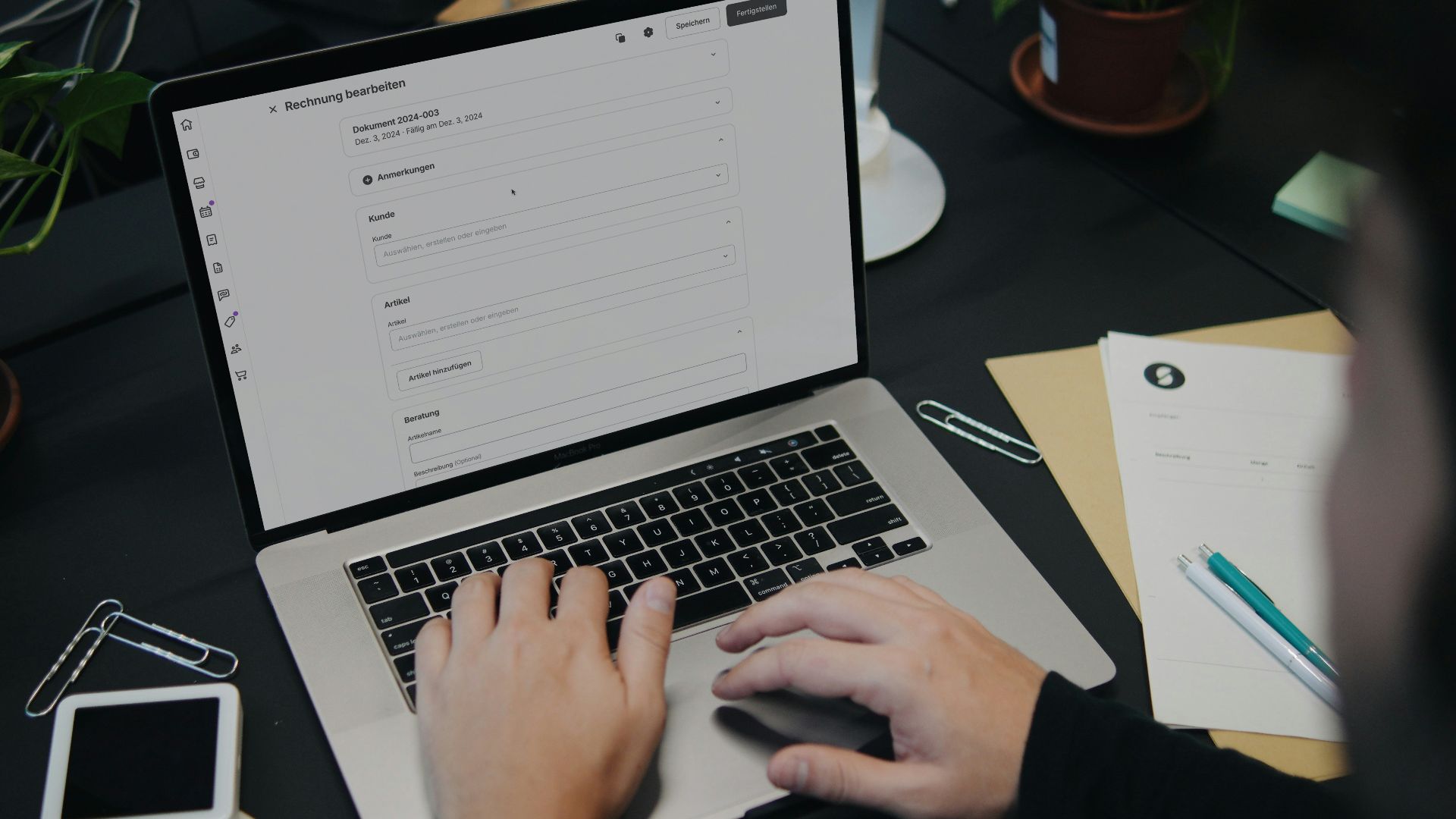 A person sitting at a desk using a laptop computer