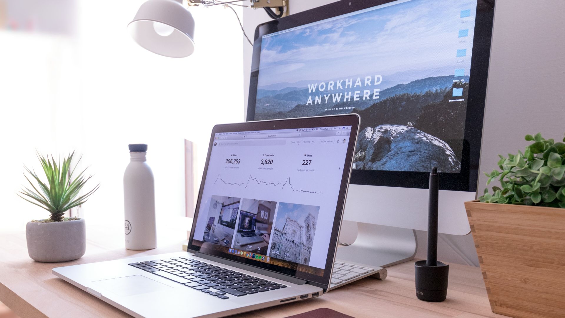 MacBook Pro on table beside white iMac and Magic Mouse