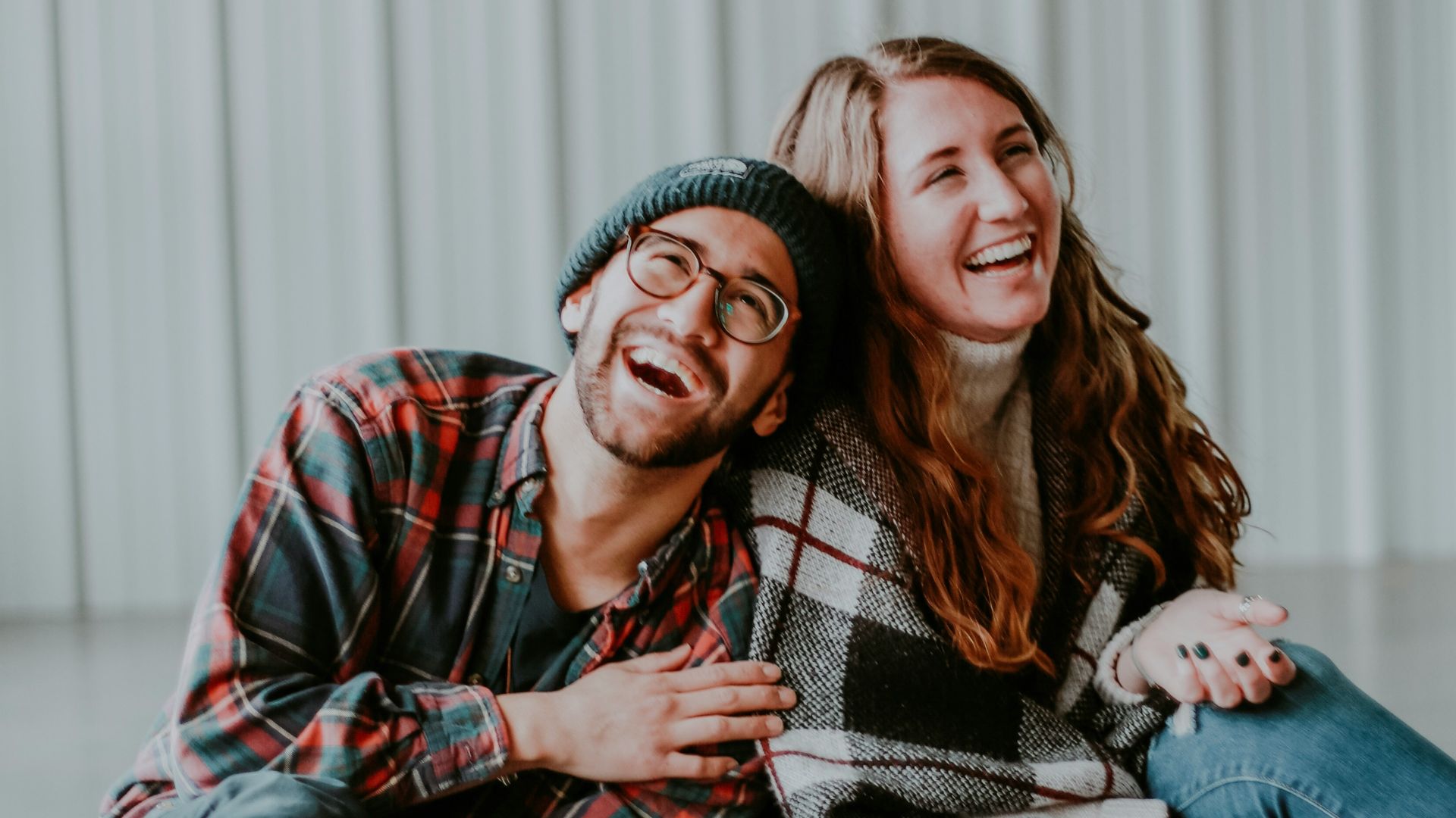 smiling woman and man sitting on floor