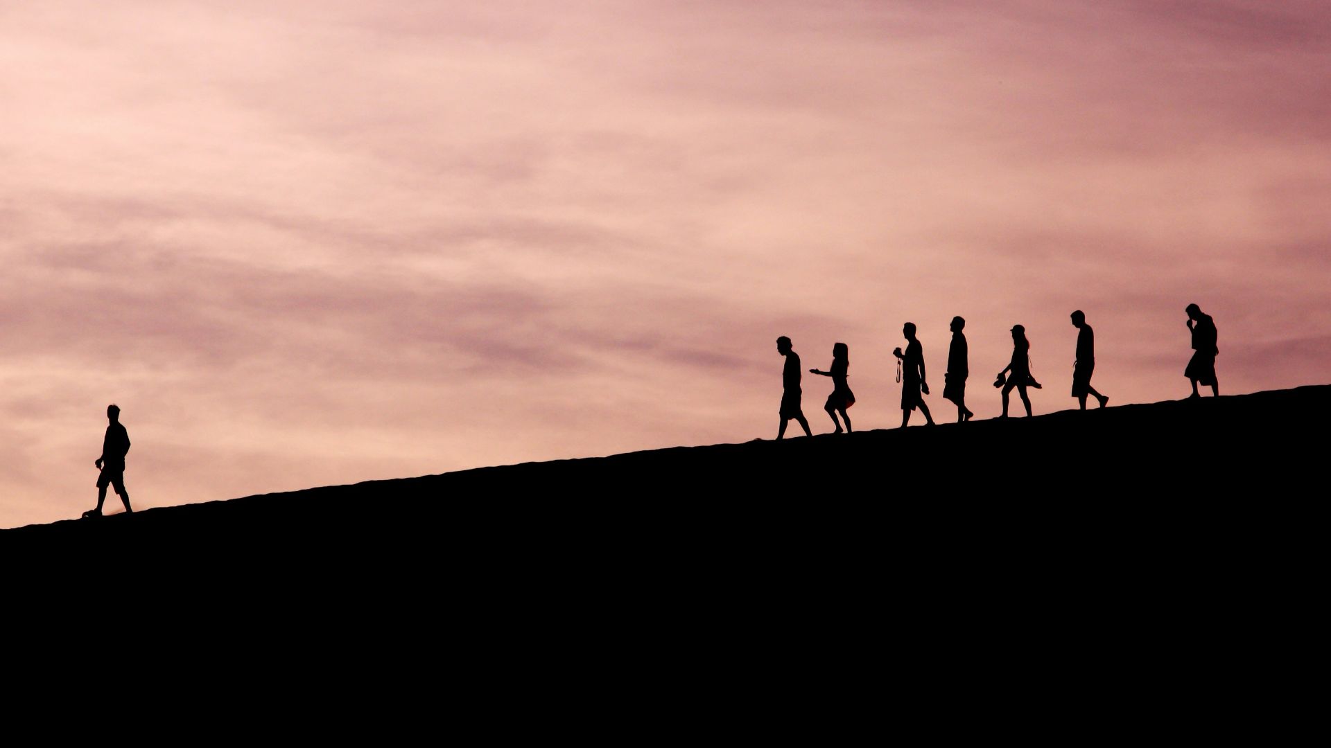 silhouette of people on hill