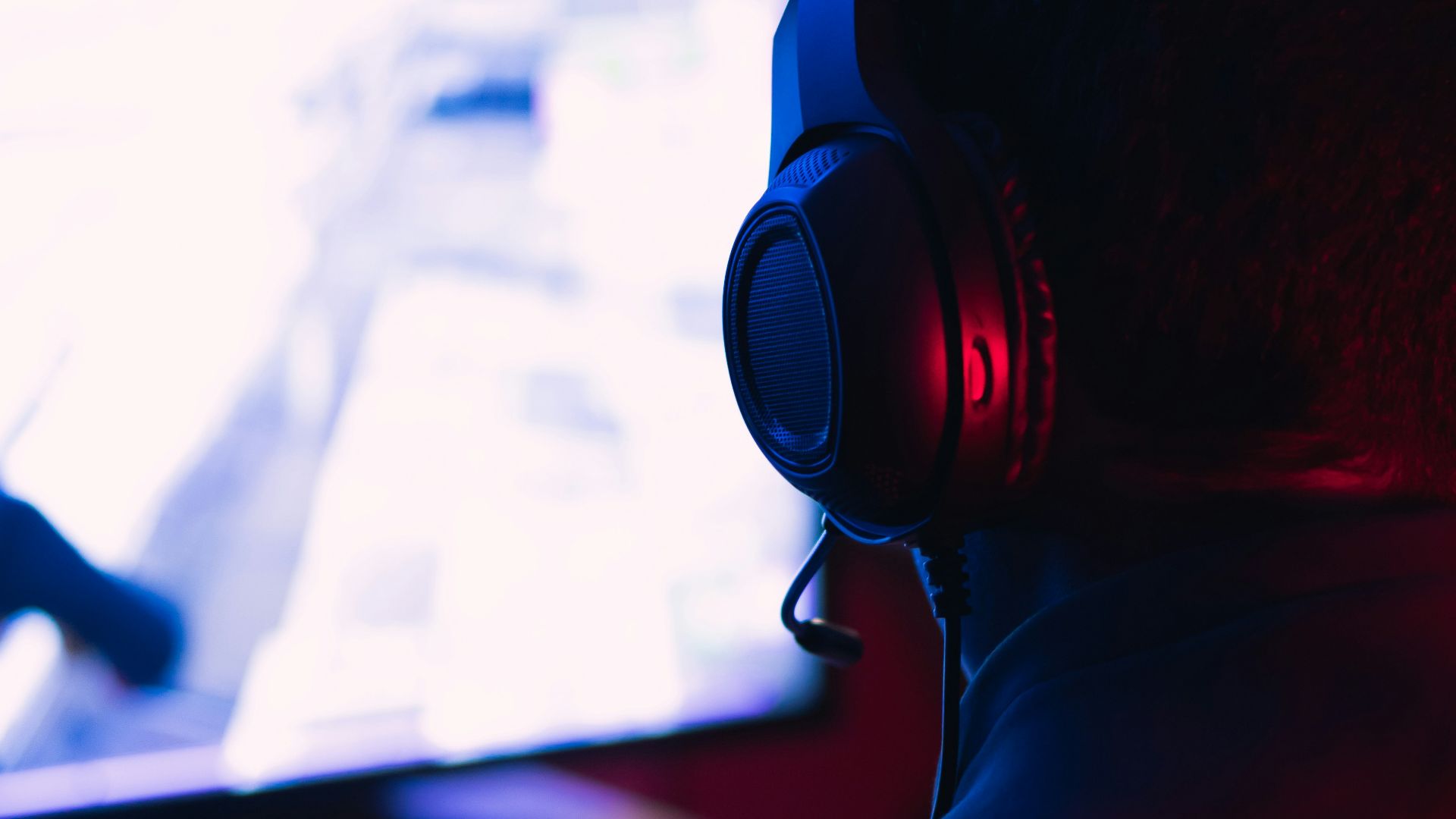 man in red shirt wearing black headphones